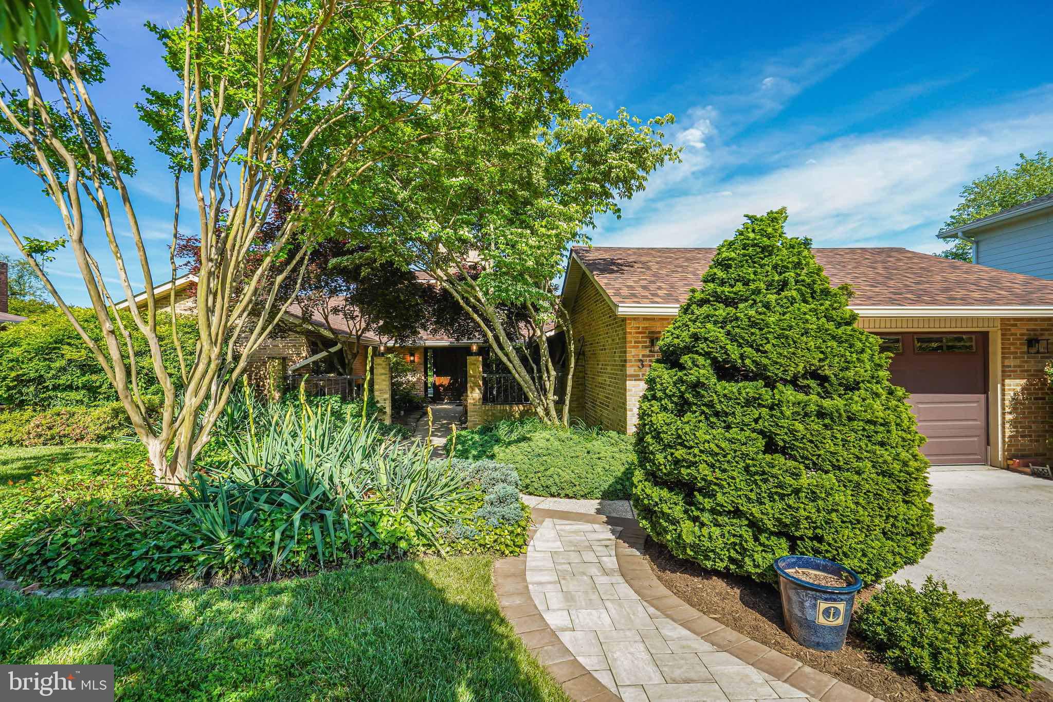 Nestled amidst the serene tranquility of Rock Creek Park, 3137 Brooklawn Terrace stands as a testament to mid-century design with sensible modern updates. Approaching the residence, guests are greeted by a peaceful courtyard entry way with a stately double-door. Stepping inside, the main level is anchored by a magnificent family room adorned with a striking stone fireplace. Vaulted ceilings soar overhead, while expansive windows and sliding glass doors invite the verdant beauty of Rock Creek Park indoors, creating a seamless fusion of nature and architecture. The heart of the home resides in the generously sized, meticulously updated kitchen— boasting a large island, 48" range, and panoramic views that transform meal preparation into a captivating experience. Adjoining living and dining spaces, bathed in natural light, provide an ideal backdrop for gatherings large and small, with wall-to-wall windows framing picturesque vistas at every turn. Outside, an expansive multi-level deck beckons, offering a private sanctuary for relaxation and entertainment amidst the tranquil embrace of nature. Here, panoramic views of Rock Creek Park unfold, complemented by privacy landscaping that enhances the sense of seclusion and serenity. Retreating to the main-level primary suite is an experience unto itself, where balcony access, a walk-in closet, and an en-suite bathroom create a private oasis of comfort and rejuvenation. An additional main level bedroom with an en-suite bathroom, a versatile third bedroom or office, and convenient amenities such as a powder bathroom, laundry room, and two oversized hall closets complete the main level's offerings. Descending to the lower level reveals a seamless transition to outdoor living, with sliding glass doors opening onto an expansive deck with a soothing hot tub and direct access to the verdant expanse of Rock Creek Park. Inside, a spacious great room, adorned with an exposed brick fireplace and complemented by two additional bedrooms, a third full bathroom, a wet bar, and ample storage space. Beyond its exquisite interiors, the property's nearly 13,000 square feet of beautifully landscaped yard offer a secluded retreat from the bustle of city life. Wooded and private, the site is enveloped in natural beauty, with Candy Cane City at the end of the street providing additional recreational opportunities amidst playgrounds, basketball and tennis courts, and scenic hiking trails. Conveniently located minutes away from neighborhood shopping on Brookville Road and a wealth of amenities in Downtown Bethesda, 3137 Brooklawn Terrace offers easy access to hundreds of shops, restaurants, and the red-line metro. With Rock Creek Park at its doorstep, residents enjoy over 30 miles of parkland, trails, and playgrounds, while the future Purple Line Metro Station promises enhanced connectivity to the surrounding area. The residence is zoned for top-rated public schools K-12, including Chevy Chase Elementary, with easy access to highly esteemed private schools.