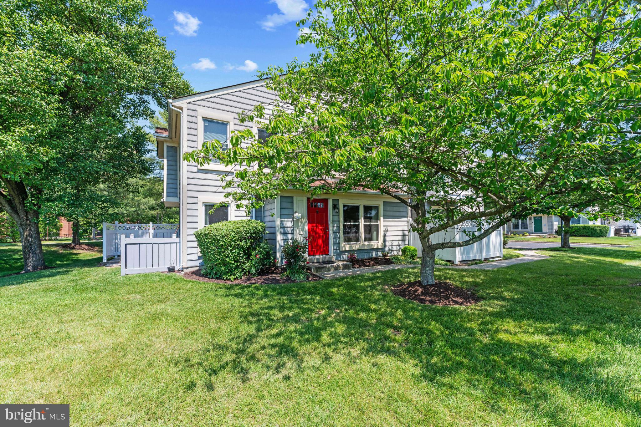 Charming end-of-row condominium offering 3 bedrooms, 2.5 bathrooms, and 1,336 finished square feet in the desirable Village at Greens of Patuxent community.   A beautifully landscaped side entrance accented by a vibrant red door welcomes you inside the main level foyer, complete with a convenient coat closet. The open-concept layout begins with a bright formal living room to the right, featuring plush carpeting and abundant natural light. To the left, durable vinyl flooring flows seamlessly into the formal dining room and continues into the spacious eat-in kitchen.   The kitchen is thoughtfully designed with stainless steel appliances, a custom backsplash, gorgeous countertops, ample shaker-style cabinetry, and a breakfast area with direct patio access, creating an ideal space for both everyday living and entertaining. A convenient laundry closet with a combination washer and dryer unit and a powder room complete the main level.  Upstairs, the upper level offers three comfortable carpeted bedrooms and two full bathrooms. The spacious primary suite features a walk-in closet and a private en-suite bath with a standing shower.   Outdoor living is enhanced by a private patio with a privacy wall, while the desirable end-unit location provides the added benefit of a side yard for extra outdoor space and privacy.  Residents enjoy two parking spaces, access to common areas, and community tot lots/playgrounds.