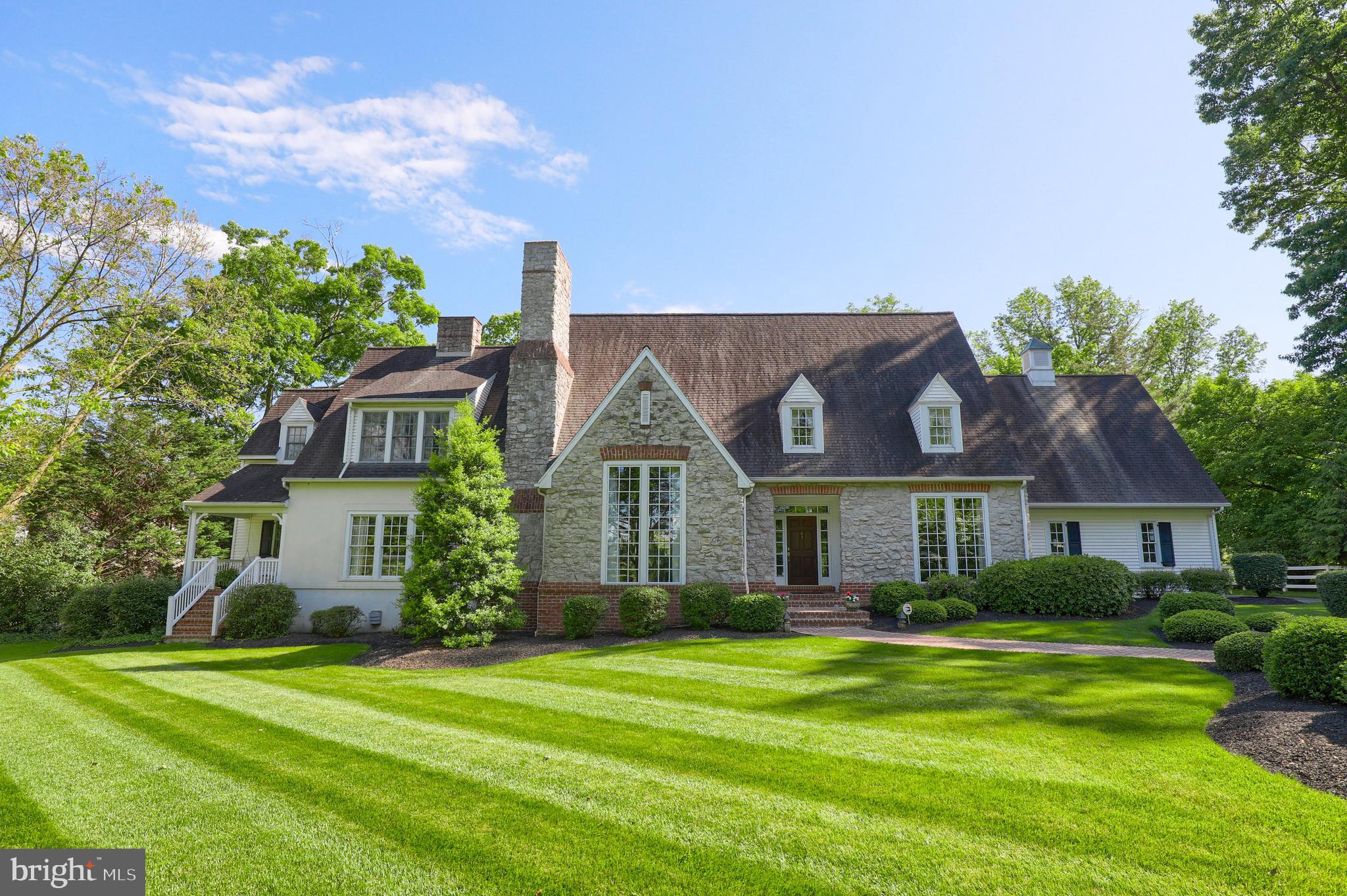 Here is your once-in-a lifetime opportunity to own this magnificent, 5-bedroom stone home on Hunsicker Road, one of Lancaste' s most picturesque streets.  From the moment you walk through the front door, you notice builder, Harry Black's solid construction and fine millwork, and architect, Jack Arnold s perfectly proportioned rooms. With its southern exposure, natural light floods the kitchen that is outfitted with granite countertops, subzero fridge, Dacor gas cooktop, two dishwashers, and a butler s pantry. Enjoy spending time in the vaulted sunroom that opens to the vaulted living room with wood-burning Rumford fireplace. The first floor master suite offers 2 walk-in closets and a marble bathroom with soaking tub. Upstairs are three light-filled bedrooms with walk-in closets and bathrooms.  The finished lower level has a wet bar, full kitchen, custom sleeping nook, fireplace, guest room and bath, and an exercise room.  At the rear of the 1.09 acre lot is a slate patio perfect for entertaining. Then behind a white fence is the pool surrounded by beautiful flower garden, mature trees, and a charming barn for changing.  The home also features cherry floors on all three levels, 3 laundry rooms, a first floor office, and a 3-car garage.  Best of all, at the end of the street is a quaint covered bridge crossing the Conestoga River leading to Amish farms. It doesn't get any more idyllic than this.