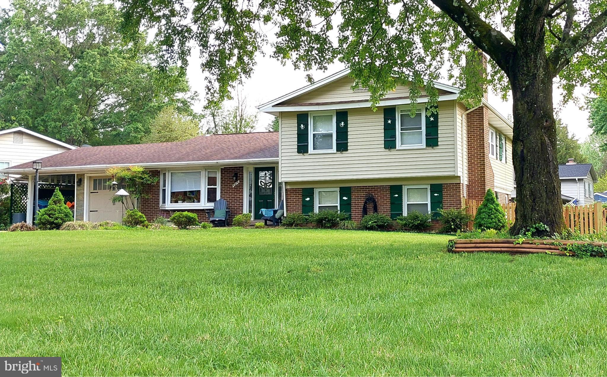 Welcome to this 4 BR/3 BA home that offers a tranquil suburban oasis. Hardwood and tile flooring throughout, beautifully updated kitchen and baths, a one-car garage with additional attached carport, built-in workshop behind the garage, and gorgeous patio and yard. The living room features hardwood flooring, coffered ceiling, and a lovely built-in with glass shelving and cabinets. The separate dining room’s sliding glass doors lead to the outdoor living space. The stunning kitchen, includes stainless steel appliances, gas range, granite island, and pantry. Upstairs you will find 3 of the 4 bedrooms, including the large primary suite with hardwood flooring, built-in shelves, a walk-in closet, and an impressive stone wall with a built-in bio ethanol, ventless fireplace (decoration only). Updated full bath completes the suite. Two additional bedrooms and full bath complete the upper level. The lower level provides a wonderful space for relaxing or entertaining friends and family. The 4th bedroom is also on this level, along with a half bath. At the end of the hall is the well-organized laundry and huge lighted storage area that runs under the entire main level. A beautifully manicured lawn adorned with seasonal ornamentals surrounds the patio and pergola seating area, complemented by the grilling area on one side and a stone fire pit on the other. The backyard is fully fenced. Located in the Woodson pyramid. Conveniently close to major commuting routes, parks, shopping and dining.