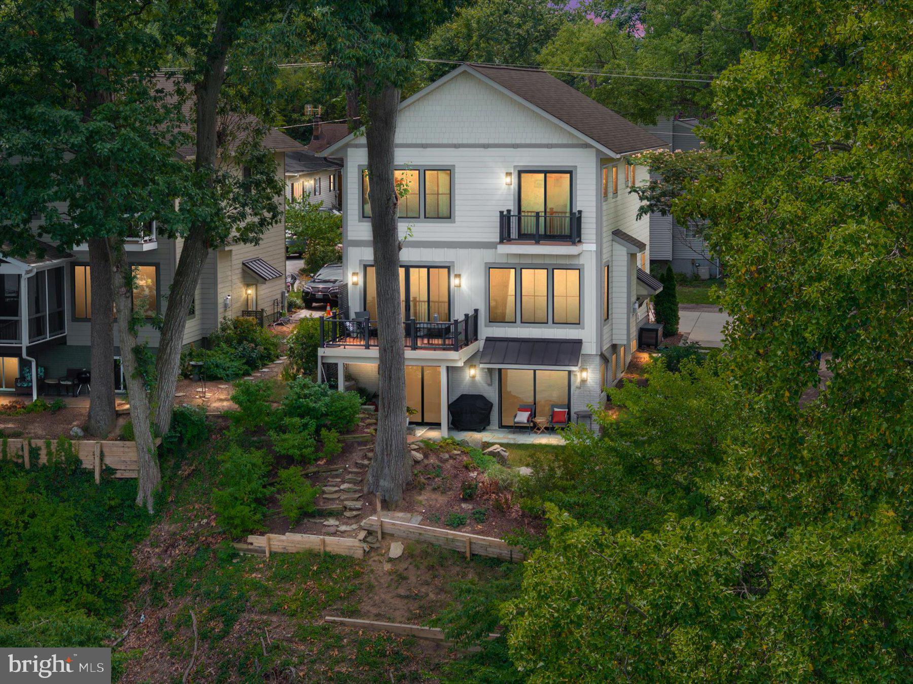 Tucked away on a private lane shared by just three homes, this custom-built waterfront home overlooks the South River and offers the perfect blend of privacy, tranquility, and unforgettable panoramic open-water views. Completed in 2022, it combines timeless design, luxury finishes, and the peace of mind that comes with newer construction, allowing you to spend more time enjoying the waterfront and less time maintaining your home. Designed to make the most of its exceptional setting, every detail reflects thoughtful planning, quality craftsmanship, and timeless style.
The main living areas were designed to capture the river views, with expansive windows that fill the home with natural light and create an easy connection to the outdoors. At the heart of the home, the gourmet kitchen features 42-inch cabinetry, stainless steel appliances, a generous center island, abundant pantry storage, and opens effortlessly to the dining and living areas, where the South River becomes the backdrop to everyday living.  A dedicated office on the main level provides the perfect work-from-home space and can easily serve as a guest bedroom, adding flexibility to fit your lifestyle.
Step outside to the waterside deck and take in the panoramic South River views, where boats, wildlife, and spectacular sunsets create a backdrop that changes every day.
The primary suite is a private retreat featuring its own waterfront balcony, a spacious sitting area, oversized walk-in closet, and a spa-inspired bath complete with a luxurious steam shower.
The walk-out lower level expands the home's living space with radiant heated floors, a full wet bar, and direct access to the waterfront, providing exceptional flexibility for entertaining, recreation, overnight guests, or multigenerational living.
The waterfront lifestyle extends well beyond the home with exceptional community amenities, including a waterfront clubhouse, boat ramp, kayak launch, fishing pier, and community piers, making it easy to enjoy everything the South River has to offer. Here, you'll enjoy the rare combination of waterfront privacy and everyday convenience, just minutes from historic Annapolis, Edgewater, local coffee shops, waterfront dining at Mike's Crab House, and convenient access to Routes 50 and 97. Whether you're searching for a full-time waterfront residence or the perfect weekend retreat, this home offers the very best of South River living. Come experience it for yourself.