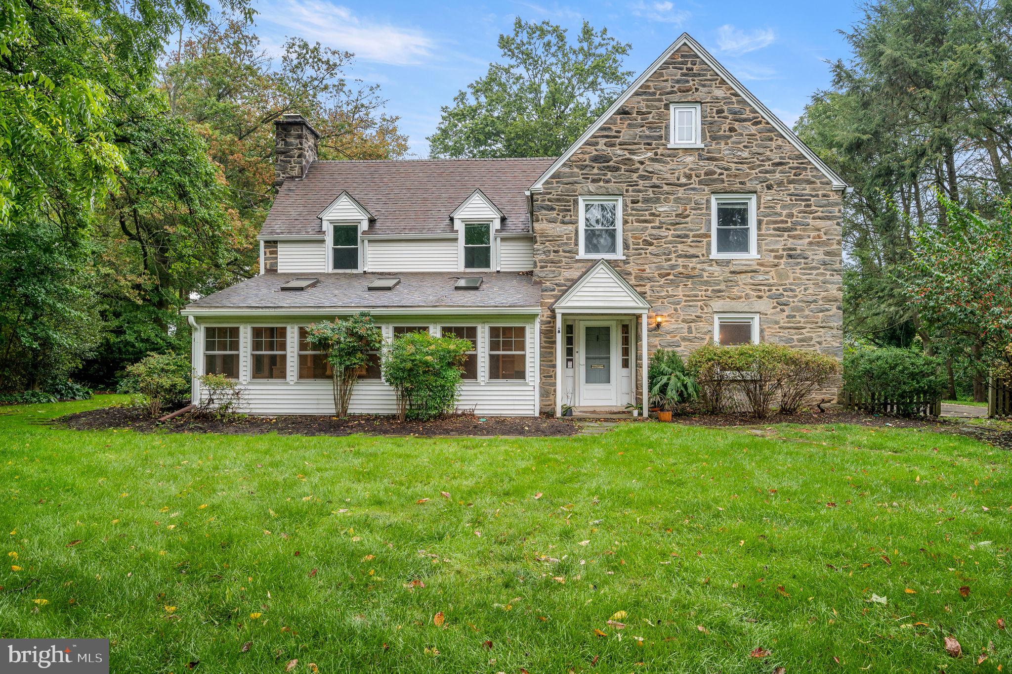 This is a very special opportunity in Swarthmore! The price adjustment will give the buyer the chance to transform this beautiful stone house into their dream home. The house is for sale in as-is condition.
3 Crest Lane is a beautifully built 1930’s 3-story stone house located in highly desirable Swarthmore Borough. The listing includes a separately deeded lot; a rare opportunity to purchase a double lot property. The home is well-designed and laid out with four bedrooms and 3-½ baths. The extra lot is located in front of the main entrance, providing an attractive garden scene for hosting special events, playing your favorite outdoor game, and gardening. As you enter the home you will step into the foyer that connects to the dining room and the living room. The formal living room is well proportioned and has a wood burning fireplace flanked by windows and built-ins. Off of the living room is a huge family/sun room with three skylights and built-ins. This room features many windows that showcase the privacy and natural light provided by the additional lot. The dining room has a crystal chandelier and two corner built-in cabinets. The kitchen is spacious and it has a generous amount of cabinets and counter space. From the kitchen there is access to the patio and the driveway. A gas fireplace separates the kitchen from the office space that has built-in bookcases and its own mini-split air conditioner. On the second floor you will find the primary bedroom with an en-suite bathroom, a large bedroom with a walk-in closet and built-in bookcases. A third bedroom and a hall full bathroom completes the second floor. The third floor consists of a bedroom with an en-suite bathroom and a walk-in closet, a perfect bedroom for those looking for their own floor and privacy. The mechanical systems are well maintained and serviced. The house is within the highly regarded Wallingford-Swarthmore School District.