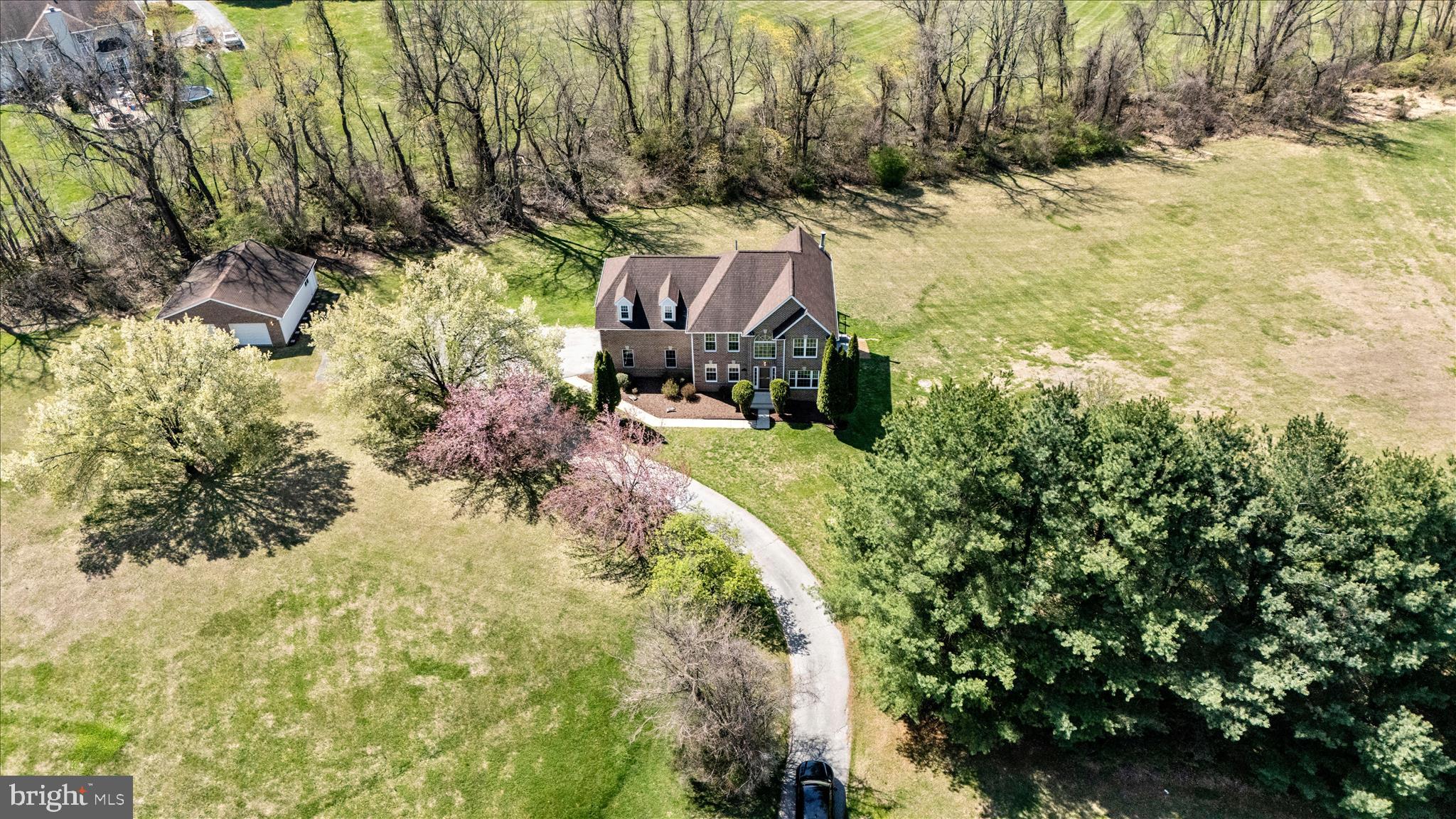 Buyer financing fell through last minute. Price improved, this is your opportunity! Nestled in a quiet, well-established community, this beautifully maintained home offers the perfect blend of comfort, space, and convenience. Thoughtfully designed with everyday living and entertaining in mind, the home features bright, open living areas filled with natural light and a functional layout that suits a variety of lifestyles. The main level offers generous living and dining spaces, ideal for gatherings or relaxing at home. The kitchen provides ample cabinetry, soft-close cabinets, and counter space, with a thick quartz island, countertops, backsplash, and top-of-the-line stainless steel appliances. Flowing seamlessly into the adjacent area is the living room, with two-story ceilings and a modern chandelier that makes a statement for easy entertaining. Upstairs, you’ll find spacious bedrooms with plenty of closet space, including a comfortable primary suite designed for rest and retreat with a large walk-in closet, a modern en-suite primary bath complete with a separate soaking tub, frameless shower doors, and quad sconces adorned over dual vanities. 
Step outside and enjoy the private outdoor space with an expansive deck, additional detached 2-car garage, and patio —perfect for morning coffee, weekend barbecues, or simply unwinding after a long day. 
The large front yard is filled with tall evergreen shrubs and a long driveway leading to the house for privacy. Located close to Baltimore National Pike with plenty of shopping, dining, Centennial Park, and major commuter routes, MD-125, US-29 Columbia Pike, this home offers both tranquility and accessibility. 
Don’t miss this opportunity to own a wonderful home in one of Woodstock's desirable Edrich Manor neighborhoods.