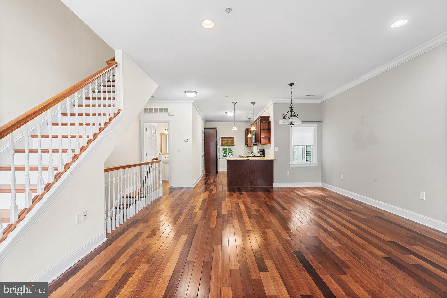 A spacious townhouse offering GARAGE parking, and a blend of modern elegance and comfortable living in a sought-after neighborhood. This impressive residence features three bedrooms, a versatile den, and two and a half bathrooms. You'll find the home to be deeper from front to back than most others, so it feels less vertical than the competition. Upon entering, you are greeted by a convenient garage with direct access to the lower level, which includes a flexible bonus room ideal for a family room, playroom, home office, or fitness area. Sliding patio doors lead to a private, fenced backyard, perfect for outdoor enjoyment. The main living level showcases an open and airy layout, highlighted by a spacious kitchen equipped with stainless steel appliances, quartz countertops, a large pantry, and a breakfast bar. The kitchen seamlessly flows into the expansive living and dining area, boasting abundant natural light, soaring ceilings, and elegant wide-plank hardwood flooring in living/dining area and all bedrooms. The second floor hosts two well-proportioned bedrooms, a full bathroom, and a conveniently located laundry room with linen storage. You can feel the elbow room on each floor. The upper level is dedicated to the master suite, featuring a generously sized bedroom, a spa-like bathroom with an oversized shower and a standalone soaking tub, ample closet space, including his, hers, a linen closet, and a private balcony. This exceptional townhouse offers the convenience of garage parking and is ideally situated on the cusp of Pennsport and Queen Village. It provides easy access to the city and major thoroughfares like I-95. This is a remarkable opportunity to acquire a stunning and spacious home in a prime location.