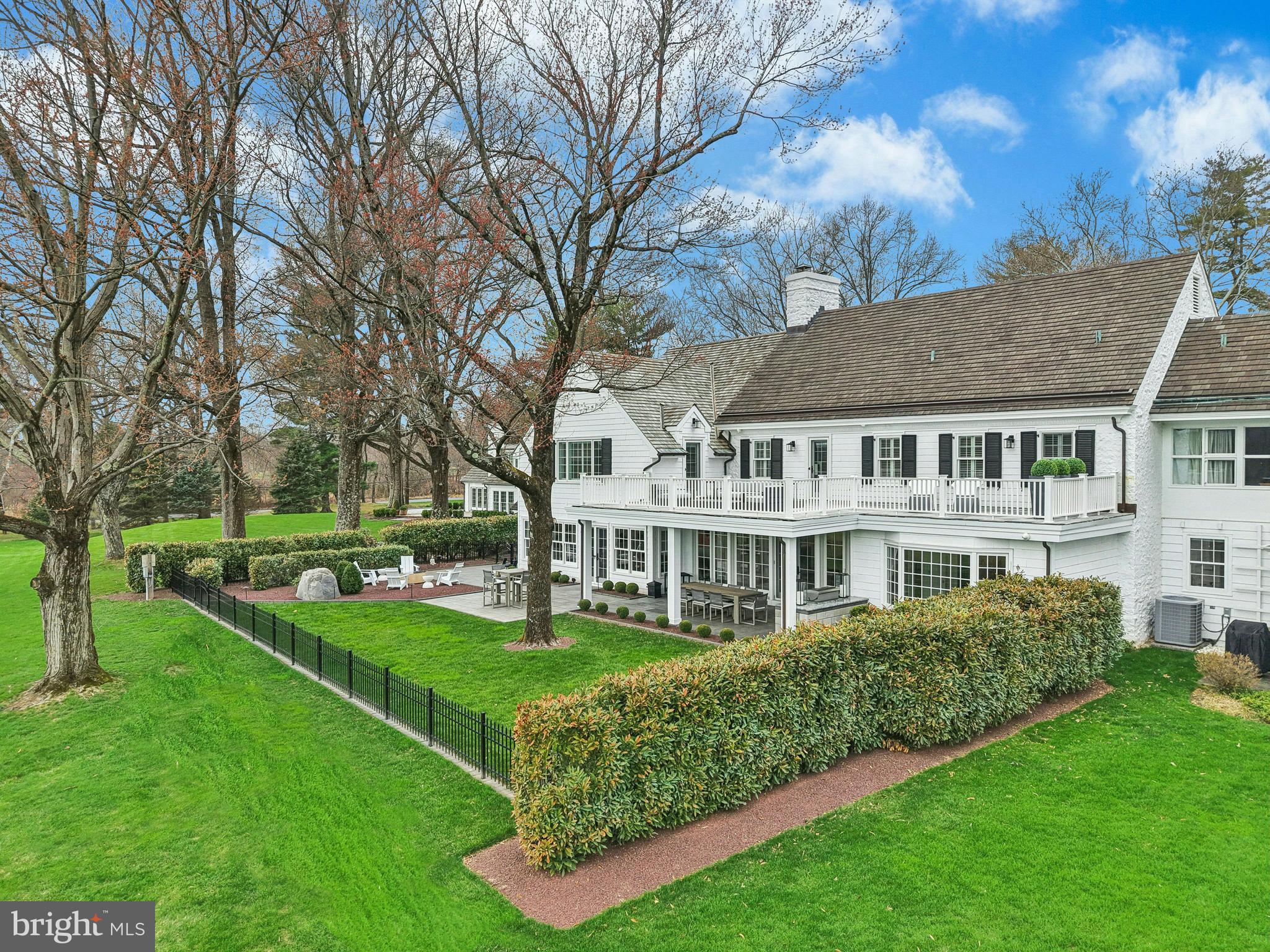 This may be the best home you have ever seen…..On a private road in a world-class neighborhood, surrounded by mature trees and manicured lawn, this exceptional home has panoramic views over 22 acres of meticulously tended grounds, within walking distance to the Weyhill Golf Course of the Saucon Valley Country Club. This noteworthy property, in coveted “Old Weyhill”, is part of an exclusive eight home enclave that is reminiscent of a New England village green.
Weyhill Circle boasts every amenity one would expect, with a newly remodeled and gracious design. Beautifully redone, with sophisticated additions, there are walls of windows in every room to frame the pastoral and protected vistas. Breathtaking at entrance, an expansive coffered-ceilinged living room is sun-filled with a wonderful flow for entertaining, opening to a stunning covered porch and outdoor kitchen, beautifully landscaped with sunset views. Adjacent, the enormous family room, also with coffered ceiling, boasts a bar, second fireplace, built-in bookcases and a south-facing wall with charming window seats.  An extraordinary and expansive kitchen offers high-end appliances, newly opened to an inviting dining room. Throughout, attention to detail is evident in the custom built-ins and bookcases, crown moldings and fabulous windows, with multiple doors beckoning one outside. Hardwood floors enhance every room, on every floor, while an elevator accesses three levels.
The sumptuous, new primary suite will delight and impress.  A generous primary office opens to a cathedral-ceilinged master bedroom with fireplace, walls of windows and full house deck with incredible long-distance vistas. The elegant primary bath, with dressing room and custom walk-in closet, will soothe and pamper.  Three additional bedrooms, laundry and 2 baths complete the second floor.  A wonderful bonus, the third floor offers an additional family room.
On the lower level, a custom designed wine cellar is adjacent to the elevator, for easy access. There is a work area with a quarter bath and 2025 custom cabinetry. A 20 KW generator and HIK Connect technology offer peace of mind. The new, oversized three car garage has a special alcove for your Golf Cart …. available with SVCC approval.
Weyhill Circle invites one to linger and enjoy the beauty of this environment, in a privileged position amidst a 22 acre piece of paradise …. all within the private roads of the Saucon Valley Country Club.  Rarely does a home offer such sophisticated ease of living, in a premiere location, surrounded by an outside environment that invites you, daily, to walk the acreage and private roads.  On the bluestone patio, overlooking bucolic views, the everyday backdrop includes wildlife by day and a brilliant umbrella of stars by night.  Here, worry-free luxurious living exists in a location that rarely becomes available, in a setting that is one of Saucon Valley’s best.
