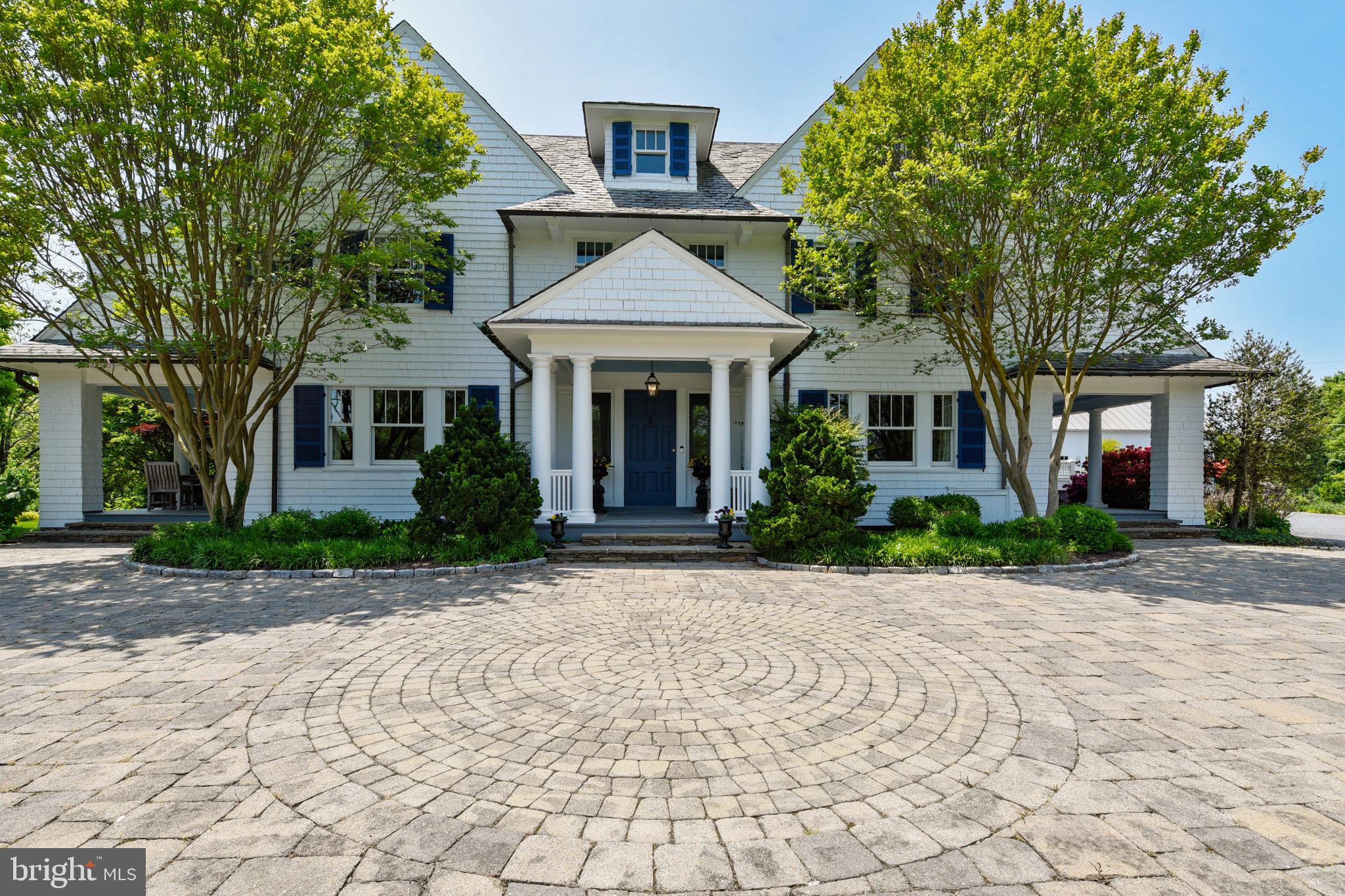 Sited on 3 exquisitely landscaped acres, this majestic New England style Colonial has over 7700' of warm inviting living space.  Perfectly positioned on arguably one of Ruxton’s most desirable lots with extensive mature flowering landscape as well as hand-crafted stone hard scaling this 6 bedroom, four full bath, one half bath, three fireplaces, Lothorian built infinity pool, hot tub and a nearly 2000’ 2 story three car garage is not to be missed.  Lovingly restored and updated by current owner of 20 years.  Walk into the grand foyer with open sight lines to the sweeping porches that flank the dining room and formal living room as well as family room.  The expansive family room has wall to ceiling bookshelves, wood burning fireplace and three sets of French doors that open to the side porch as well as the back patio and hot tub.  Trish Houck designed gourmet kitchen has coffered ceilings, massive center island, prep sink, Wolf appliances and Butler’s pantry. The primary suite consists of the entire south wing of the second floor. This suite has a large bedroom with custom bookcases and sitting area that is adjoined to a larger sitting room with gas fireplace.  Relax in the spa-like primary bath with breathtaking views. The second level consists of three additional bedrooms, two full bath, large laundry room and a sleeping porch that is converted to a four-season room.  Third level has two additional bedrooms, one full bath, exercise room and large game room/family room with custom bookcases.  The outdoor space is simply STUNNING.  The bluestone patio expands the entire width of the home with a custom built-in barbeque, gardens and fish pond.  Large level lot on the south lawn with steps down leading to a built-in firepit.  Stone paver drive leads to the parking area and 3+ car garage.  This is the perfect home for that serene outdoor living, entertaining or simply enjoying the amazing lot.