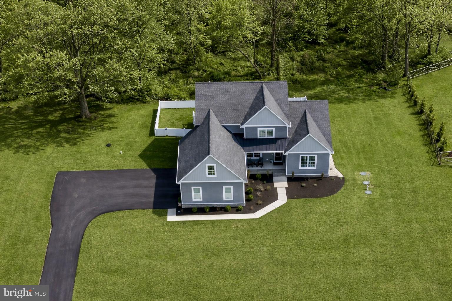 Discover an exquisite blend of modern luxury and serene living in this stunning home nestled within the prestigious Willow Branch East community. Built in 2022, this exceptional home boasts 3,011 square feet of meticulously designed space, offering an unparalleled lifestyle for those who appreciate the finer things in life. There is also approximately 1478sf of unfinished basement. Step inside to find an open floor plan that seamlessly integrates the living, dining, and kitchen areas, creating an inviting atmosphere perfect for both entertaining and everyday living. The gourmet kitchen is a chef's dream, featuring high-end stainless steel appliances, including a built-in microwave, down-draft cooktop, and wall oven, all complemented by a spacious island and ample table space. The elegant dining area and formal dining/office room provide the perfect backdrop for memorable gatherings. The heart of the home is the family room, where a stunning gas fireplace with glass doors and a stylish mantel creates a warm and inviting focal point. Recessed lighting and ceiling fans enhance the ambiance, while luxury vinyl plank flooring adds a touch of sophistication throughout. This residence offers four generously sized bedrooms, including a main-level bedroom for convenience. The primary suite is a true retreat, featuring a lavish en-suite bathroom and expansive walk-in closets. Step outside to your own personal oasis, where a spacious deck overlooks a beautiful yard that backs to tranquil trees, providing a serene escape from the hustle and bustle of daily life. The 1.42-acre lot offers ample space for outdoor activities and gatherings, while the attached side-entry garage and asphalt driveway provide convenience and curb appeal. Additional highlights include a main-floor laundry room, a tankless water heater for endless hot water, and an unfinished walkout basement with a Sauna and endless potential for customization. Enjoy relaxing in the outdoor Hot Tub located just steps away from the Sauna. This home is not just a residence; it's a lifestyle choice that embodies luxury, comfort, and tranquility. Also included are 6 wall mounted TV’s, Sauna, Hot Tub and a one year home warranty.  Easy commute to DC, the Western Shore and the Eastern Shore beaches. Sellers are offering a $5000.00 allowance for paint.