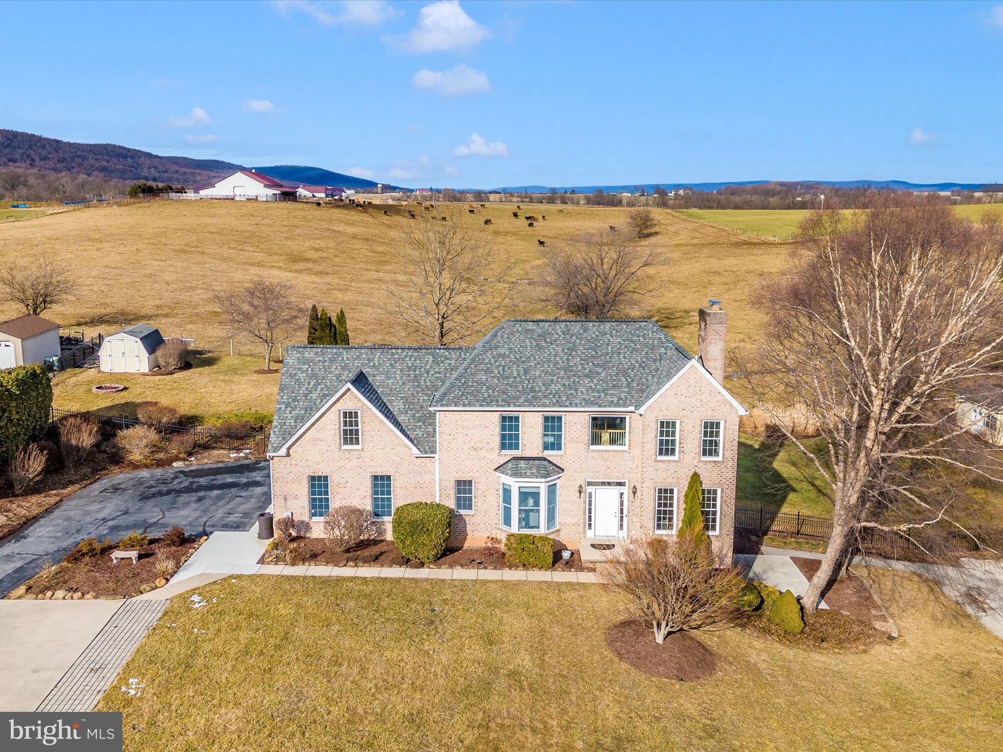 Welcome to your dream home with a lower level au pair/nanny/in law suite or college student independent living featuring it's own dedicated driveway and laundry!  This country estate sits back off the road and features breathtaking views of the Potomac river valley, ag preserved farmland and mountains in all directions.   You are minutes from historic hiking, quaint towns and villages, the C and O canal, the Potomac and Shenandoah Rivers, new grocery with pharmacy and even the MARC train.   This 5 bedroom, 3.5 bath luxurious dreamlike setting home is impeccably maintained with many thoughtful heart and home features.  From the chef's kitchen, granite counters, beverage cooler to sun drenched windows and gorgeous refinished hardwoods on the main level.  The kitchen and family room open to a fabulous formal dining room and all weather sun room large enough to entertain with ease just steps from the Michael Phelps 15 ft swim spa.  Your family and guests will appreciate tons of play space and an enormous maintenance free deck to capture sunrises and stunning sunsets, all year long.  Privacy is a given in this intimate lush landscaped setting with features allowing for friends, family and quiet evenings in.  Surrounded by black aluminum fencing, stained and stamped concrete pathways, spilling hydrangeas, berry filled nandina and orchard fruit bearing trees, Spring blooming Kwanzan cherry trees, the ultimate escape awaits.  Retreating to the bedroom sleeping floor offers plush new carpet and padding, large bedrooms and a thoughtful 2nd floor large laundry.  The oversized primary has views in all directions, 3 large closets, sitting areas and a devoted hallway entrance offering privacy and a restful feeling of peace.  The bedroom opens right up to a large serene sunken tub bathroom with double sinks, double vanity and double shower.  The aesthetics are abundant and the worry free maintenance and upgrades are plentiful including newer windows, roof, HVAC, flooring throughout, well pressure tank, UV light and water systems, swim spa, deck, sealed driveway, man cave garage with cabinetry/tool storage and new front door - to be painted in warmer weather!  Welcome home to your forever country estate!