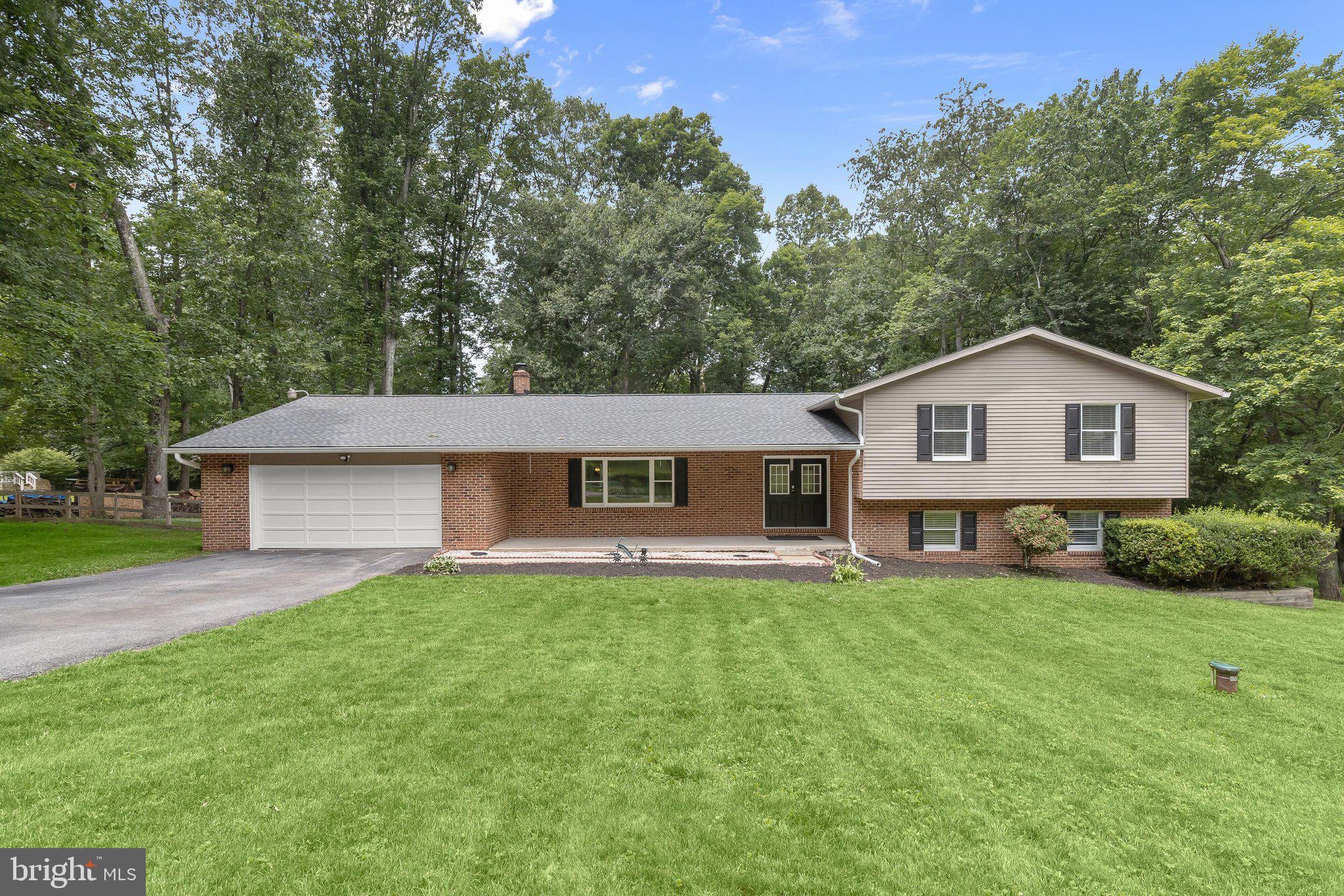 Welcome to 5686 French Avenue, a spacious split-level home nestled on a picturesque lot in the desirable Carrol Estates community of Sykesville. A charming covered front porch creates a warm welcome and sets the stage for the inviting interior. Step inside to discover a bright and airy main level enhanced by luxury vinyl plank flooring and an abundance of natural light. The sun-filled living room provides the perfect gathering space and flows seamlessly into the dining room, where direct access to the screened-in patio makes indoor-outdoor entertaining effortless. The eat-in kitchen is thoughtfully designed with stainless steel appliances, granite countertops, decorative backsplash, and a casual dining area overlooking the backyard, creating an ideal setting for everything from morning coffee to family dinners.
The upper level offers a comfortable primary suite complete with a walk-in closet and private en-suite bath, while two additional bedrooms and a full hall bath provide ample space for family and guests. The lower level expands the home's living space with a cozy family room centered around a brick-profile wood-burning stove, perfect for relaxing evenings. This level also features backyard access, two additional bedrooms, a full bath, and a convenient laundry area. An unfinished basement level offers abundant storage space and endless possibilities for future expansion, a workshop, home gym, or hobby area.
Outdoor living is equally impressive with a screened-in patio, custom rear patio, fenced backyard, and an expansive tree-lined lot that provides a peaceful and private backdrop. Whether hosting summer barbecues, enjoying outdoor recreation, or simply unwinding in nature, this property offers plenty of space to enjoy. Additional highlights include an attached two-car garage and numerous recent improvements, including a new roof, luxury vinyl plank flooring throughout the main level, rear patio, fencing, and more. Combining generous living spaces, thoughtful updates, and a tranquil setting, this home is ready to be enjoyed for years to come.
Some photos have been virtually staged