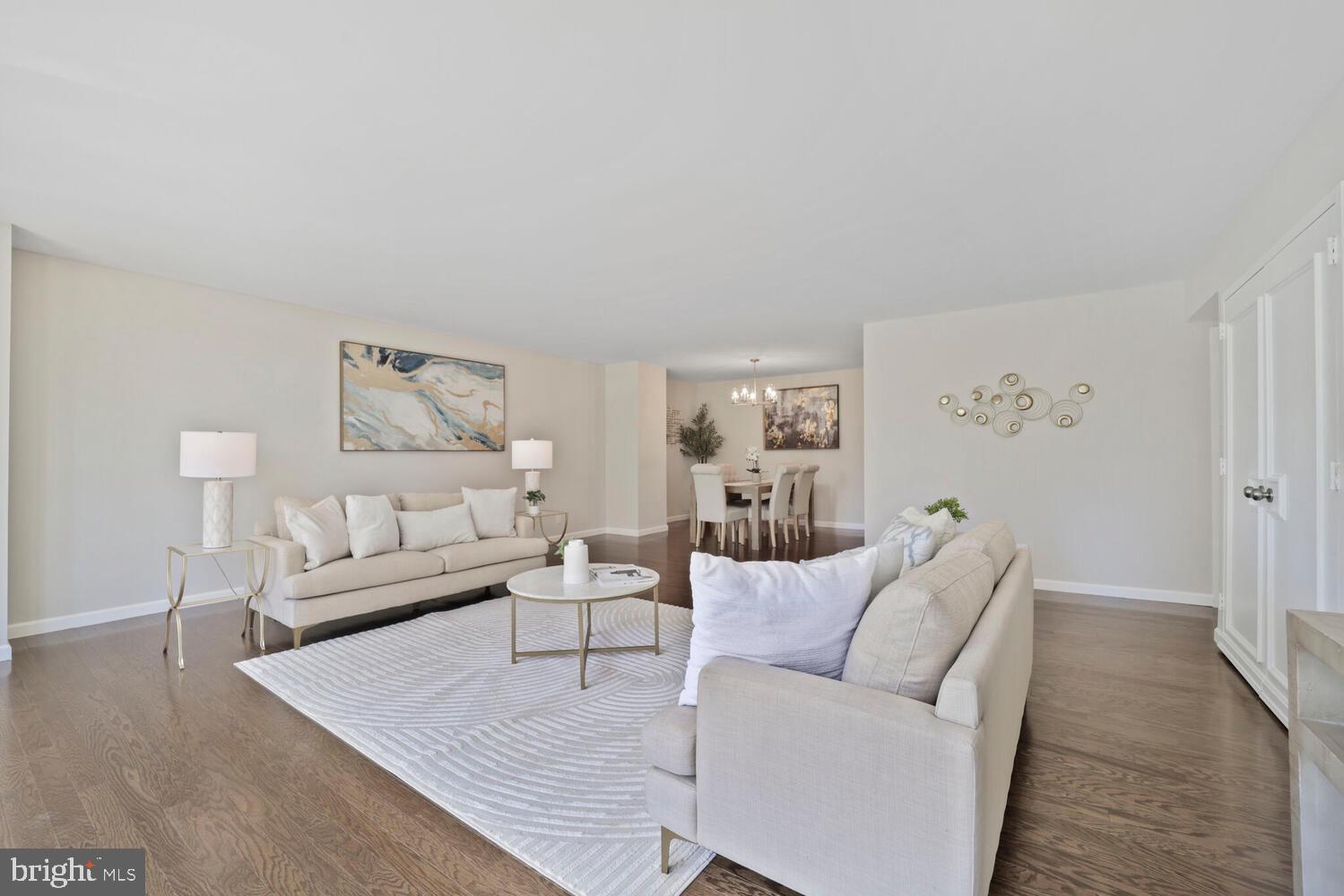 Step into this expansive condo at Tower Villas, where generous room sizes and thoughtful updates set it apart. With over 1,110 square feet of living space, this home offers the comfort and scale rarely found in condo living.

The brand-new hardwood floors and fresh paint create a warm, modern feel throughout. The oversized living room—an impressive 21' x 20'—features a wall of glass that floods the space with natural light and opens to a private terrace with tranquil tree and park views along 9th Street. The layout flows seamlessly into a formal dining area, ideally positioned just off the kitchen.

The kitchen is both stylish and functional, equipped with stainless steel appliances and gray Corian countertops. The large, south-facing bedroom (14' x 16') boasts abundant closet space and easy access to the full bathroom just outside the door. You'll also appreciate the full-size laundry room with ample storage and a stacked washer and dryer.

One dedicated garage parking space P2-7 is included.

Tower Villas offers exceptional amenities, including a 24-hour concierge, outdoor pool, and fitness center. Enjoy unbeatable convenience just two blocks from Virginia Square Metro, four blocks from Ballston Metro, and moments from Ballston Quarter's vibrant shops and dining.