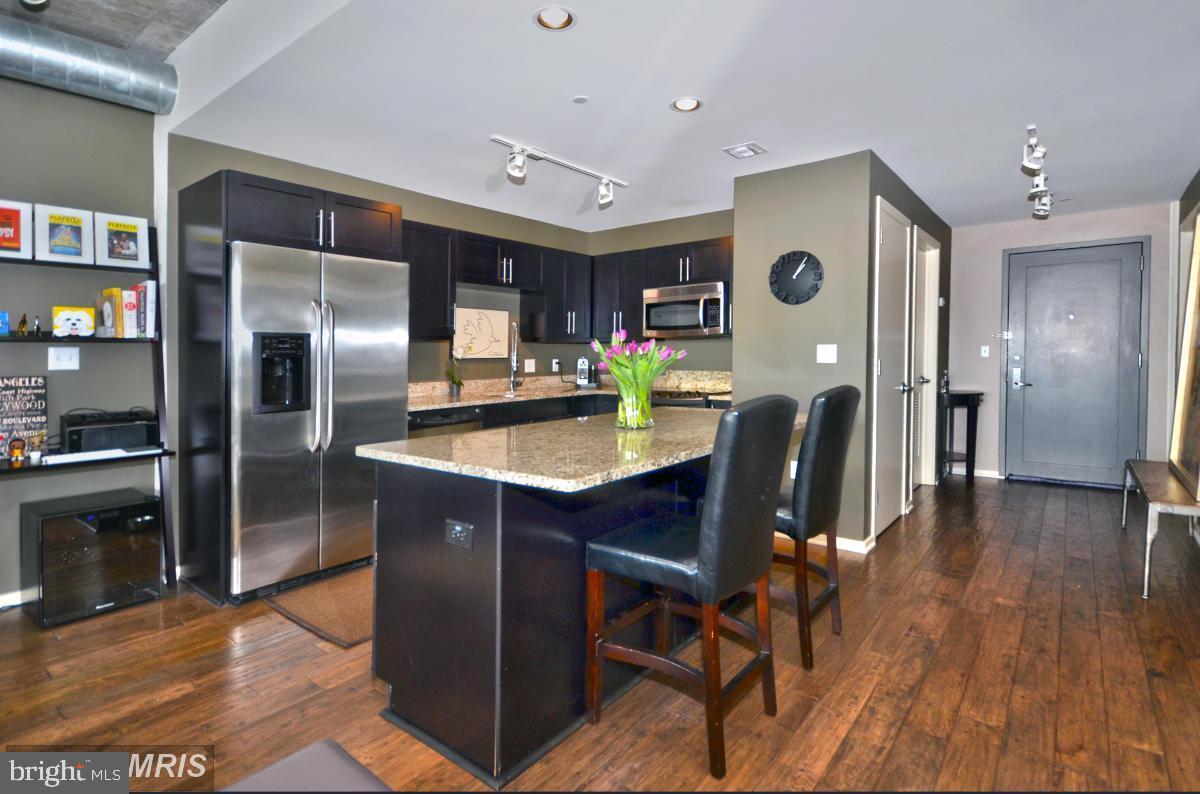 EXTRAORDINARY ARCHITECTURAL DETAILS AND AMENITIES ABOUND IN THIS LUXURY CONDO LOCATED IN THE SILO POINT COMMUNITY OF LOCUST POINT! This 4th floor unit features over 1,300 sq. ft. of living space, hardwood floors & 10ft ceilings throughout, an open floor plan with a spacious living room with a dining area, gourmet island kitchen with granite/limestone counters & ss appliances, a generously sized bedroom with a walk-in closet and a spa bath with double sinks, large soaking tub, & a separate shower, an additional half bath for added convenience, a private balcony with sweeping skyline views, and 1 car parking.  This full service building offers unsurpassed amenities including a 24hr front desk attendant, state of the art sky lounge, concierge, fitness center, meeting room, & billiards room!  This is city living at it's best!