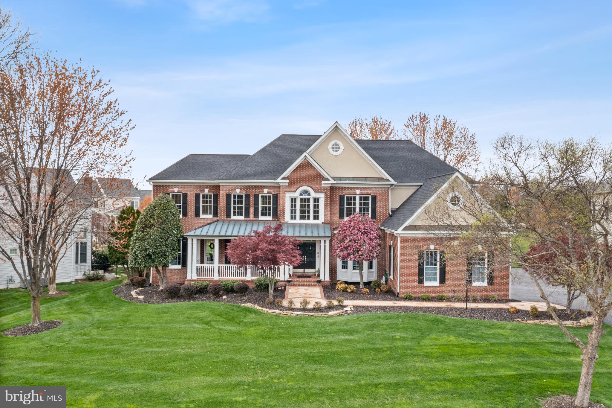 Welcome to your dream home nestled in a quiet, picturesque cul-de-sac on one of the most coveted streets in Ashburn. This stunning one-of-a-kind modified Winchester Browning was customized to provide unparalleled elegance and livability. This meticulously maintained home is on a beautiful ½ acre lot with an inground sprinkler system, mature trees, and a gorgeous flagstone front walkway. The house features 4 ensuite beds, 5.5 baths, 2 home offices, 2 private basement level flex rooms next to full bath with over 5,000 sq ft of living space on the top two levels plus 2000 sq ft of finished space in the basement (county records are incorrect). The main level has 9' ceilings, a massive eat-in kitchen featuring GE Monogram appliances, granite countertops, double ovens, and a large island. An intuitive, whole house smart home system has been seamlessly integrated to incorporate the lights and alarm/camera system. Custom trim complements the dramatic dark solid hardwood floors that flow throughout. Upstairs, the expansive primary suite has a separate sitting area, light and bright flex area, and an updated bathroom with quartz countertops, separate vanities, and a heated floor. Each generously sized bedroom has its own walk-in closet and upgraded ensuite bathroom. Stay comfortable year-round with a multi-zone, multi-stage HVAC system, granting individual temperature control for each bedroom. The basement is primed for entertainment with an impressive wet bar area featuring granite countertops, beverage refrigerators, 2 tap kegerator, and 2 wine coolers with space for 364 bottles. The home theater is equipped with a 100” projector, 2 additional TVs, and integrated surround sound for the ultimate movie or sports experience. Additional flex space, gas fireplace, upgraded full bath, and large unfinished storage area round out the lower level. Outside there are over 1000 sq ft of screened-in porch and deck for endless outdoor enjoyment. The 3-car garage features wiring for 2 electric car chargers, epoxy flooring, slatwall organization system, and built-in cabinets and storage racks for optimal functionality. The exterior of the home was constructed with low-maintenance materials and has been impeccably maintained. Notable upgrades include a new roof with 6” gutters (2019), a Hubitat smart home system (2020) integrated to all core components of the property, upgraded bathrooms, and so much more. See the documents section for an impressive list of home improvements. With all of the hard work already done, the only thing needed is a new owner! Don't miss the iGuide tour for a personalized walkthrough of the property!