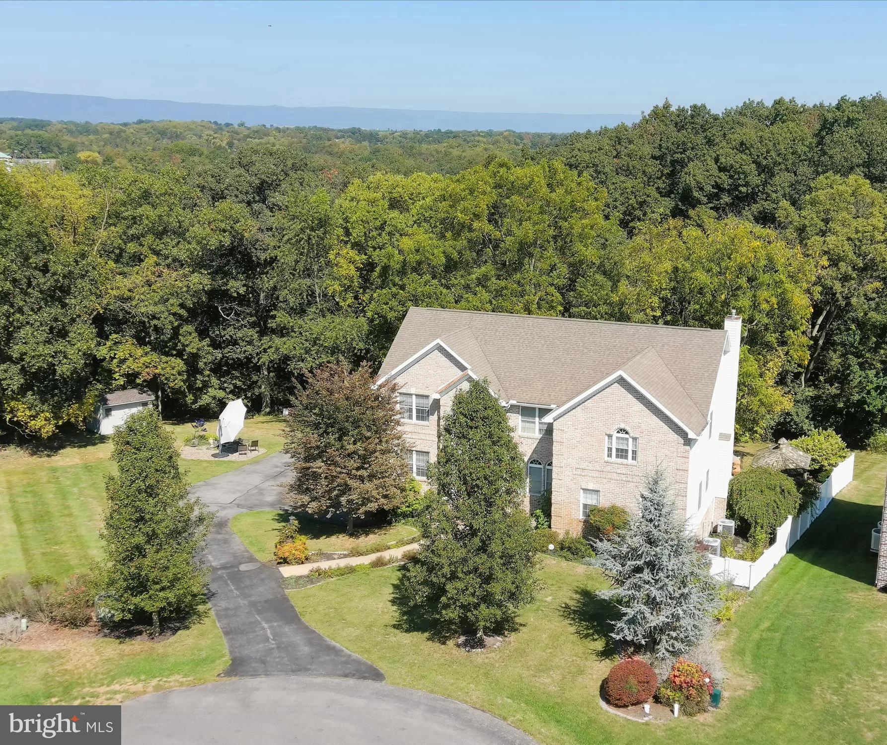 Experience the beauty of this property - inside & outside.  Tranquil & Peaceful Wooded Setting in Greencastle Greens!   Home with main level primary & upper level primary plus finished walk-out-to grade lower level - multiple living options for you!
So, let's start with describing the chance to have your own wooded backdrop, paths to walk in the woods, a deck & a patio to sit out & enjoy your mornings & evenings.  A beautiful fenced in-ground pool installed by Flohr Pools & serviced consistently two times a year to open & close with new filter & heater within the past 2-3 years.  Plus, a cabana for quiet times or entertaining times.  This is a beautiful custom-built 5BR/4.5BA with close to 4400 finished SF home located on a cul de sac in Greencastle Greens.   Walking into the foyer, you will find a room for everyone in this home with abundant windows & beautiful views.   Starting with the main floor, a cozy office w/built-in bookcases, large dining rm, kitchen w/stainless steel appliances, breakfast nook, family rm w/gas fireplace w/french doors to the deck.  Also located on the main level is a primary suite plus main level laundry area.  
The upper level has three generous-sized bedrooms w/hall bath & a huge second primary suite.  Main & upper level w/hardwood floors throughout. 
The lower level which could be used as an in-law suite or great entertaining space has a small kitchenette, full bath, large living area w/French doors leads to the brick patio & pool area.  In addition, you have the utility rm, storage area, plus an additional laundry hook up & hallway to the oversized two-car garage.   Exterior with electric dog fence to keep your puppies at home.
This home has been well-maintained with only one owner.  Plan your visit today to see your future wooded retreat with private space in the Greens!  Seller is motivated!   Pool opening May 22 and Power washing May 23.