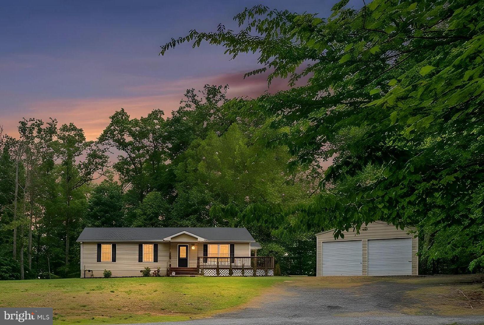 Positioned on a beautifully wooded lot with a welcoming presence from the moment you arrive, 3150 Sareth Lane offers peaceful one-level living, comfortable interior spaces, and a setting that feels tucked away while still remaining close to everyday conveniences. Built in 2004, this three-bedroom, two-bath home is surrounded by trees that create a cozy and private atmosphere, giving the property a warm and inviting feel year-round. As you approach the home, the setting immediately stands out with its attractive positioning and serene surroundings. Inside, the layout is open, functional, and designed for comfortable everyday living. The family room serves as the heart of the home, offering generous space for relaxing along with abundant natural light that pours in throughout the day. The large, open feel of the main living areas creates an easy flow between spaces while still maintaining a cozy atmosphere that guests immediately notice and appreciate. The oversized two-car detached garage is another standout feature, providing excellent storage space and flexibility for hobbies, tools, outdoor equipment, or additional organization needs. Outdoor living continues the appeal of the property. The backyard is level and usable with plenty of room for gatherings, outdoor activities, play areas, gardening, or entertaining. A rear deck offers a comfortable space to relax and enjoy the peaceful setting, while the surrounding woods and frequent wildlife sightings add to the property’s retreat-like feel. With very little through traffic nearby, the home offers an added sense of privacy and comfort. Recent updates include a new roof installed in September 2025, HVAC replacement in 2023, and a new sidewalk added in 2024, helping provide peace of mind for future owners. The location offers the perfect balance of serenity and convenience, with shopping, dining, and everyday necessities just a short drive away while still maintaining a scenic, tucked-away atmosphere. Comfortable, cozy, and welcoming, this home offers the perfect balance of convenience and privacy, a place where you can enjoy nature, unwind at the end of the day, and truly feel at home.