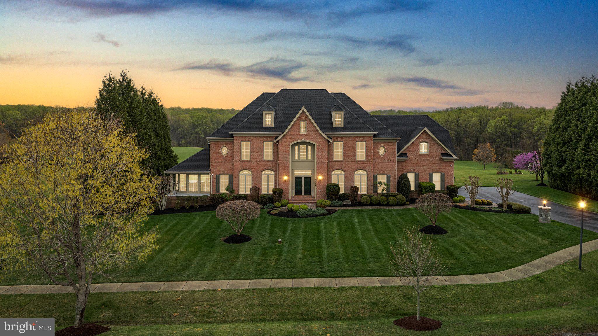 This exceptional home is the perfect blend of location, design, quality, and style, crafted for those who appreciate the joy of everyday living. Built by Craftmark, this stunning all-brick residence is sure to exceed your expectations. As you step inside the Kenwood II model, you’ll immediately recognize the thoughtful details that set this home apart. The well-planned layout effortlessly accommodates both grand entertaining and relaxed daily living.
A grand two-story foyer welcomes you, featuring a sweeping curved staircase and a formal dining room large enough for elegant gatherings. The sophisticated living room is seamlessly and elegantly connected to the sun-drenched conservatory by a see-through fireplace, which adds an air of refinement to the space. The chef-inspired kitchen is a masterpiece, showcasing custom maple cabinetry with a wine rack, beautiful granite countertops, a large island with a six-burner Viking gas range, double ovens, grill, and a Broan hood. Top-of-the-line appliances include a Sub-Zero refrigerator, Asko dishwasher, along with a dedicated work desk and walk-in pantry. Adjacent to the kitchen is the bright and airy morning room, which leads to a spacious deck offering stunning views of the property.
The expansive two-story family room serves as the heart of the home, featuring a wall of windows framing breathtaking views, a grand stone fireplace with a mantel, and a convenient wet bar. A cozy library or home office sits just off this central space. Upstairs, the luxurious owner's suite awaits, complete with a multi-sided gas fireplace, a peaceful sitting area, two walk-in closets, and a spa-like bath with a Jacuzzi tub and separate shower. Three additional bedrooms, all with walk-in closets and en-suite baths, complete the upper level.
The finished walk-out lower level is designed for both relaxation and entertainment. It boasts two distinct recreation areas: one with a stone-faced gas fireplace and the other spacious enough for a pool table, complete with a large wet bar and French doors that open to a flagstone patio and the incredible backyard. Throughout the home, meticulous attention to detail is evident, from the hardwood floors, to the elegant moldings, and custom window treatments. The home also features four fireplaces and a three-car garage.
Nestled on 2.05 picturesque acres at the end of a tranquil cul-de-sac, this is a home and setting that most can only dream of. Additionally, an external video surveillance system provides peace of mind.