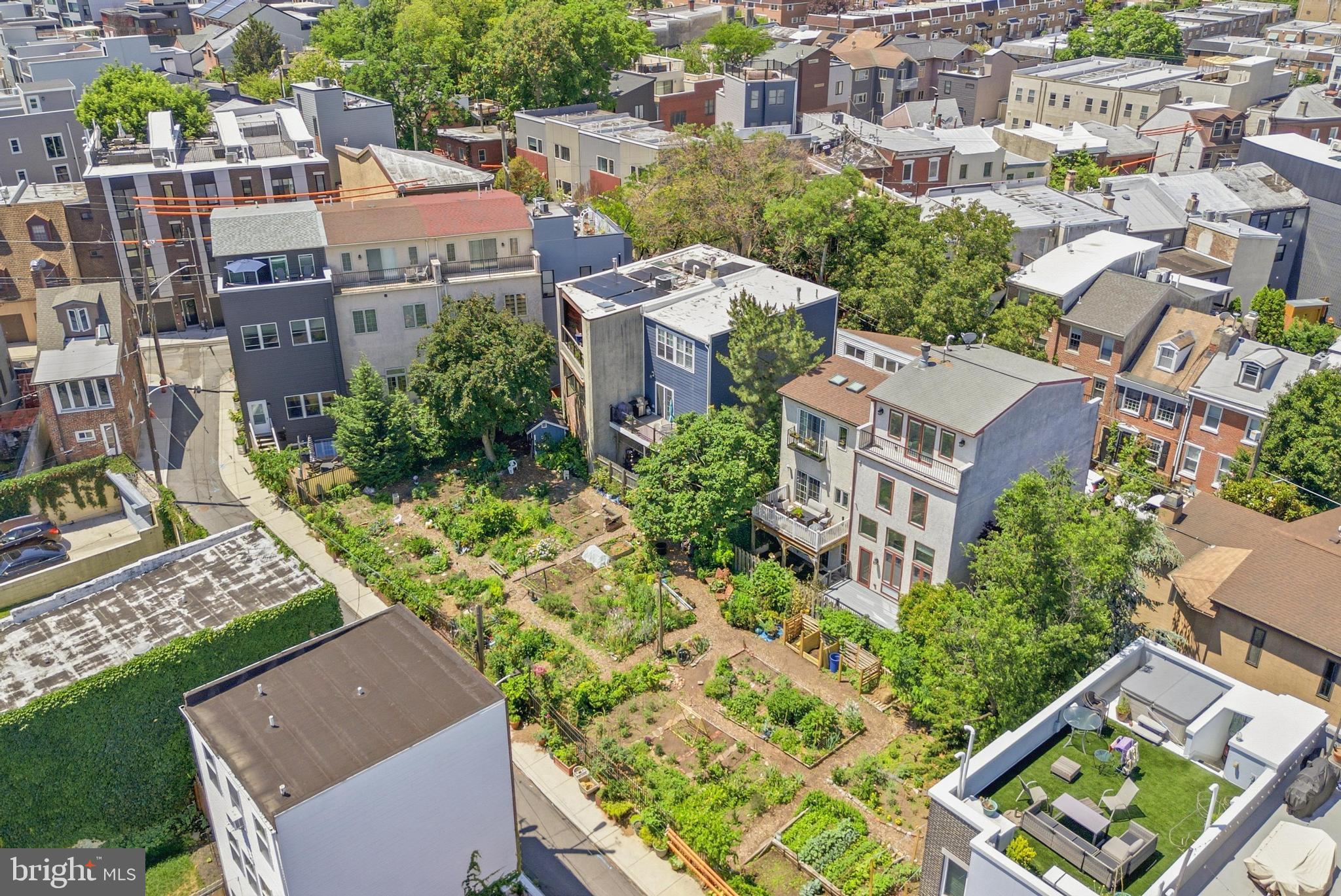 Discover a rare architectural gem that bridges the gap between high-end comfort and historic charm. Located on one of Northern Liberties’ most picturesque, tree-lined blocks, this semi-detached contemporary home offers the luxury and efficiency of a 2022 renovation while retaining a unique sense of place. Backing directly onto a lush community garden, the residence provides a private, verdant sanctuary that feels deeply rooted in the neighborhood's established character, offering a serene escape that is virtually impossible to find in standard new construction. The interior is defined by soaring 15-foot ceilings and an abundance of natural light streaming through premium Pella windows and doors. The heart of the home is a showstopping chef’s kitchen featuring a double waterfall quartz island and custom cabinetry, which overlooks an elegant formal living room anchored by a fireplace. The thoughtful floor plan scales beautifully across multiple levels, including a dedicated top-floor primary suite, a true retreat with a private office nook, dual balconies, and a spa-like ensuite with a jetted tub. Throughout the home, designer touches like imported wallpaper, California Closets, and engineered hardwoods elevate the aesthetic beyond the ordinary. Exceptional outdoor living and utility complete this luxury offering. Five distinct outdoor spaces include a redone backyard deck for seamless entertaining and dual rooftop decks that capture panoramic views of the Center City skyline and the Ben Franklin Bridge. The lower level provides a comfortable family room and guest suite, while the entry floor offers the rare city convenience of an attached garage. Situated just steps from the city's premier dining and transit, this home is a sophisticated sanctuary for the buyer who demands modern comfort within a classic Philadelphia context.