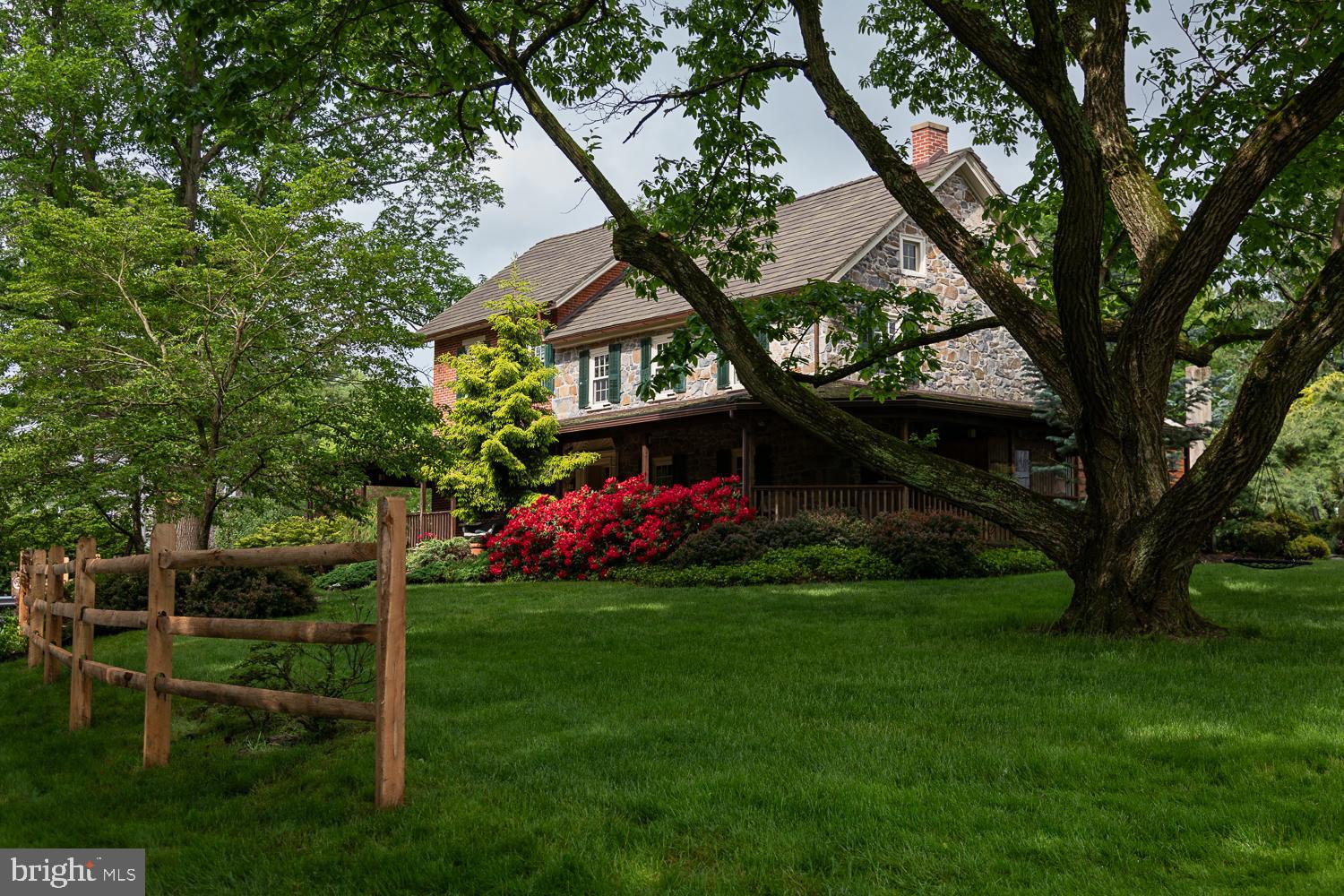 Welcome to 4217 Mill Road, also known as Les Bocages d'Chatain (The Grove of the Chestnuts)—a charming 12-acre estate nestled in the heart of Coopersburg, offering the perfect balance of history, comfort, and natural beauty. For the past 38 years, this beloved farm has been thoughtfully cared for by the same owners, and now, it’s ready to welcome a new chapter.

Steeped in history, the property was once part of the Yoder homestead and boasts a farmhouse built circa 1880, full of character and timeless appeal. Every corner of the 4635 sf home tells a story, with deep window sills, stone accents, wide plank hardwood floors, and original built-in farmhouse cabinetry. While thoughtfully updated with modern amenities, the home's rich historical charm has been preserved.

This extraordinary property features an impressive collection of outbuildings, each brimming with character and functionality. At its heart stands a magnificent three-level, circa-1800s Bank Barn, a true architectural gem showcasing timeless charm. From its hand numbered beams to its multiple horse stalls and stone façade, this barn is a stunning testament to historic craftsmanship. For the car enthusiast, the modern three-car garage is a dream come true. Not only does it provide ample space for vehicles, but it also includes a fully finished office space above, complete with electricity and heating—perfect for a private retreat or workspace.

Additional outbuildings offer even more versatility, including a spacious tractor shed with a second-floor loft, a classic smokehouse, and a functional greenhouse. Each structure adds to the property's rich history and practical appeal.

Beyond the buildings, the landscape is equally breathtaking. A serene, oversized pond invites peaceful afternoons with a picnic, while a picturesque stream meanders through the property, nurturing a thriving ecosystem of native wildlife and lush vegetation. The home’s back paver patio is a true oasis, featuring a charming gazebo, a tranquil pond, and thoughtfully designed landscaping. Adding to the property’s uniqueness is a rare grove of American Chestnut trees, a remarkable nod to the land’s natural beauty and heritage.

With its unparalleled blend of history, modern convenience, and breathtaking scenery, this one-of-a-kind property is a rare find in a fantastic location!