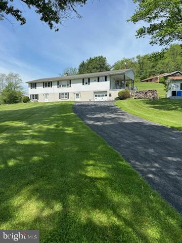 Country Living - Come see this large Ranch Home with attached Mother- in- Law suite . This home has plenty of room and storage. the main floor boasts a large Eat-in-Kitchen, Living Room, 3 Bedrooms and 1.5 Baths. A covered porch off the kitchen to enjoy your morning coffee or nature watching. Main floor Mother-in-Law suite provides a Living Room, Kitchen, Bedroom and Bath and a covered porch at rear of home. The walk in basement has a large Family Room with a fireplace with wood stove attachment, a utility room with a shower and an attached one car garage. Mother in law sweet basement provides a finished room that could have various uses along with a storage area. 2-200 AMP Electrical Service. Public Sewer and Well Water. 3 outdoor sheds, 1 of these with electrical service.
Home is being sold AS IS.
Baseboard electric heat plus Woodstove. Walk up attic.