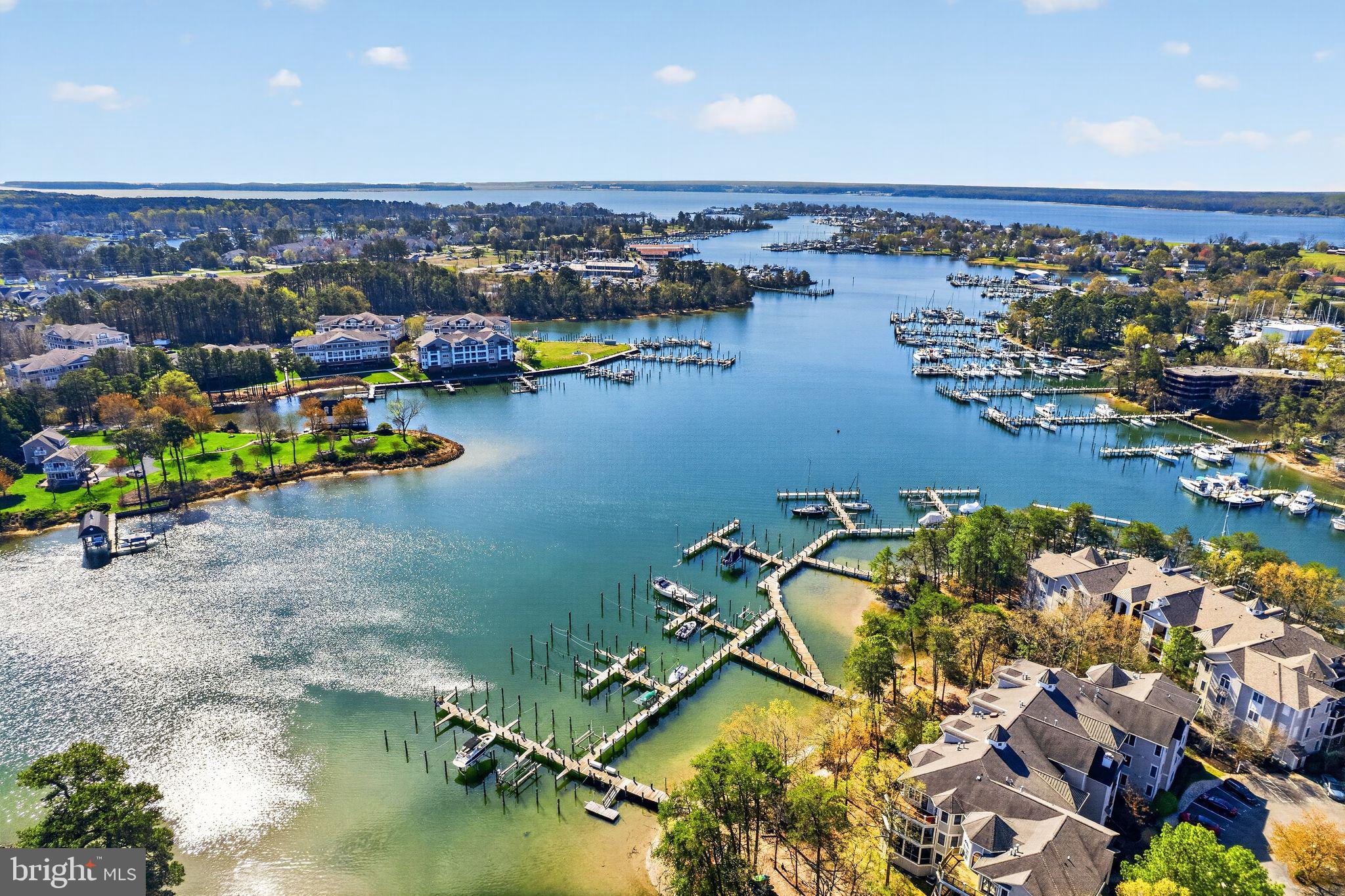 Stunning water views from this top floor unit with cathedral ceilings and natural light create a perfect waterfront retreat. The spacious three bedroom floor plan is very open, offering a primary bedroom with ensuite bath and spacious walk-in closet, and second closet, plus two additional bedrooms where there is separation of the rooms providing privacy. The kitchen features ample cabinetry, a china closet, island, granite prep surfaces, and breakfast area. A wrap deck can be accessed from the kitchen as well as main living area, and is a great place to take in the beautiful water views. There is a separate laundry room that provides additional storage, a unique and very desirable feature of the St. Michaels floor plan. Boat slips are available for separate purchase and immediately accessible to the Harbor View building where the unit is located. Solomons Landing resort style amenities in a marina community, all close to the many Solomons conveniences and attractions, create the exceptional island lifestyle. (Some rooms have been virtually staged to visualize the home's spaces)