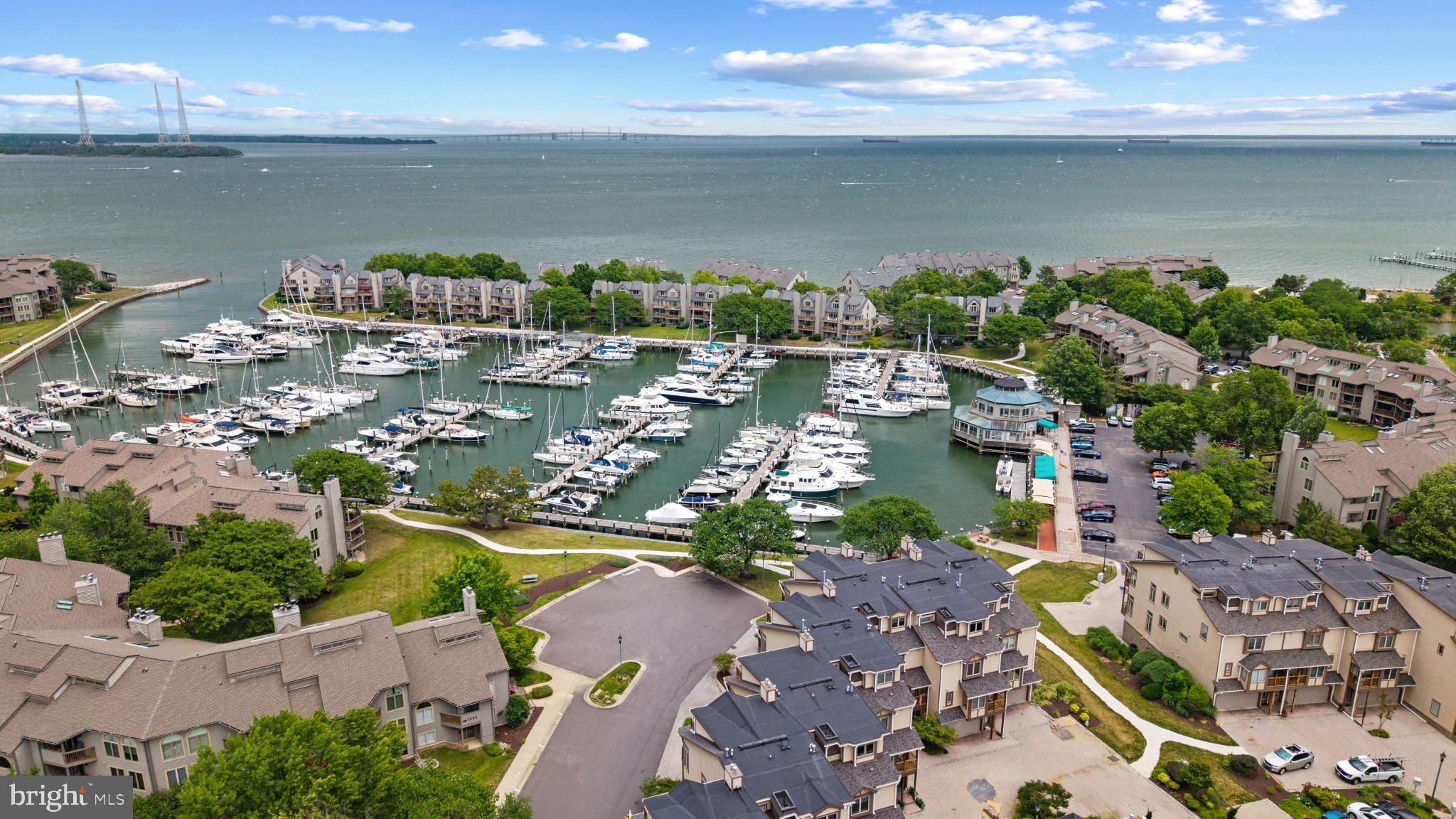 Enjoy resort-style waterfront living with harbor and Chesapeake Bay views in the gated community of Chesapeake Harbour. This beautifully updated two-level residence offers the ideal blend of comfort, natural light, and low-maintenance coastal living. Freshly painted throughout with new carpet, the home features a thoughtfully designed floor plan with over 1,900 square feet of living space, an attached 2 car garage with additional storage, and interior access for everyday convenience.

The entry level features an eat-in kitchen with white cabinets and counters, powder room and laundry  room with a few steps up to the living room. The thoughtfully designed split-level layout creates a natural separation between the home’s functional spaces and its main entertaining areas, allowing gatherings to flow effortlessly while keeping day-to-day tasks discreetly tucked away. The dramatic living area where soaring ceilings, gas fireplace with custom built-ins, and walls of windows fill the space with natural light while framing the harbor views. Step outside to the expansive full-width waterside deck, the perfect setting for morning coffee, evening cocktails, or simply enjoying the marina activity and views stretching toward the Chesapeake Bay.

Upstairs, the spacious primary suite offers a balcony, an ensuite bath with new cabinet and drawer fronts, and a peaceful retreat  for relaxing after a long day. A loft-style flex space overlooks the living room below and can easily function as a second bedroom, home office, or additional lounge area, complemented by a full hall bath.

Life in Chesapeake Harbour feels like a year-round vacation with an unmatched collection of resort-style amenities, including two waterfront pools, a private sandy beach, exclusive fitness center for a small enclave of residents, tennis and pickleball courts, fishing piers, walking and jogging paths, picnic areas with grills, scenic Chase Pond, and the security of a 24-hour attended gatehouse. The newly opened waterfront marina restaurant adds to the vibrant atmosphere with outdoor dining and live music on weekends.

Ideally located just minutes from Downtown Annapolis, Eastport, the United States Naval Academy, waterfront dining, shopping, and historic attractions, this exceptional residence also offers easy access to Washington, DC, Baltimore, and Baltimore/Washington International Thurgood Marshall Airport. Whether you are searching for a full-time residence or a lock-and-leave waterfront retreat, this home offers the very best of the Annapolis waterfront lifestyle. Welcome Home!