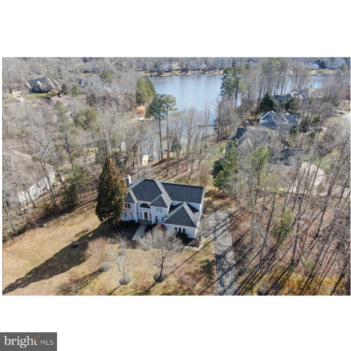 Nestled within the prestigious Fawn Lake community, this exquisite Colonial-style residence offers a harmonious blend of luxury and comfort, perfect for those seeking an elevated lifestyle. Spanning over 4,286 square feet, this meticulously maintained home features four spacious bedrooms and three and a half elegantly appointed bathrooms, ensuring ample space for relaxation and entertainment. Step inside to discover an inviting open floor plan that seamlessly connects the gourmet kitchen to the family room, creating an ideal setting for gatherings. The kitchen is a chef's dream, equipped with stainless steel appliances, including a built-in microwave, wall oven, and a down-draft cooktop, complemented by abundant cabinetry and a convenient extra refrigerator/freezer. The dining area, adorned with crown moldings and chair railings, sets the stage for memorable meals. Retreat to the primary suite, where luxury meets tranquility. Enjoy the indulgence of a soaking tub and a separate stall shower in the primary bath, along with generous walk-in closets that provide ample storage. The fully finished daylight basement, complete with a walkout entrance, offers additional living space, perfect for a home theater or recreational area. Outside, the property boasts a beautifully landscaped lot of one acre, featuring mature trees and a serene rear yard that invites outdoor enjoyment. The expansive deck provides a perfect vantage point to soak in the stunning views of Fawn Lake, where water activities abound. With private access to the lake, indulge in boating, fishing, or simply basking in the sun by the water's edge. The Fawn Lake community enhances this luxurious lifestyle with an array of amenities, including a clubhouse, fitness center, and multiple recreational facilities such as tennis courts, swimming pools, and walking paths. Enjoy the peace of mind that comes with living in a gated community, complete with security features and well-maintained common areas. This home is not just a residence; it's a lifestyle choice that offers the perfect blend of elegance, comfort, and community. Experience the tranquility of lakeside living while being just moments away from vibrant local attractions. Embrace the opportunity to call this stunning property your own, where every day feels like a retreat.