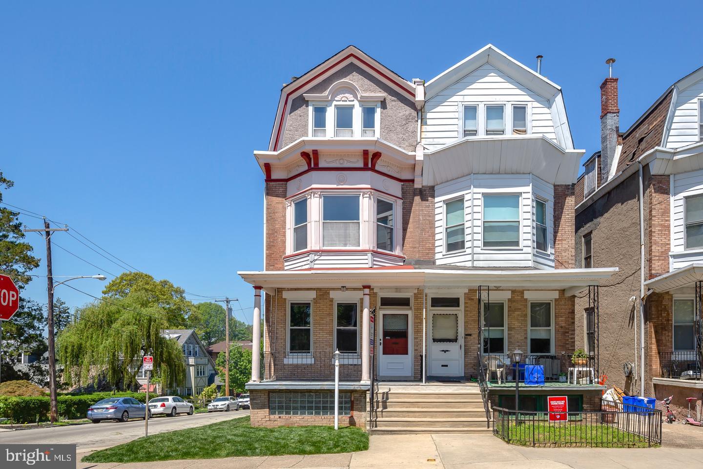 Meet this beautiful twin residence in West Mount Airy with old charm and new improvements. This home sits on the end of the block and has a ton of windows with plenty of natural light. There is an attached 1 car garage. A 5 minute walk to the regional rail Upsal Station and Germantown Avenue. Also very close to hiking and biking trails Wissahickon Park. Enter through the front door into foyer and past the original stain glass entry doorway into the spacious living room with high ceilings and brand new hardwood flooring. Walk through the living room into a formal dining room with crown moldings, shadowbox wainscoting, and a beautiful chandelier. Continue through to find yourself in an updated kitchen with large peninsula, great for dining and entertaining. Granite countertops and sleek black appliances look great. Finally enter into a mud room perfect for storage before walking outside onto an elevated wraparound porch overlooking private green backyard. Upstairs you will find 2 fully renovated bathrooms and five spacious bedrooms. Master bedroom has been renovated with walk-in closet. Other key features include a single zone automatic irrigation/sprinkler system, large full length basement with washer and dryer, brand new steam furnace.