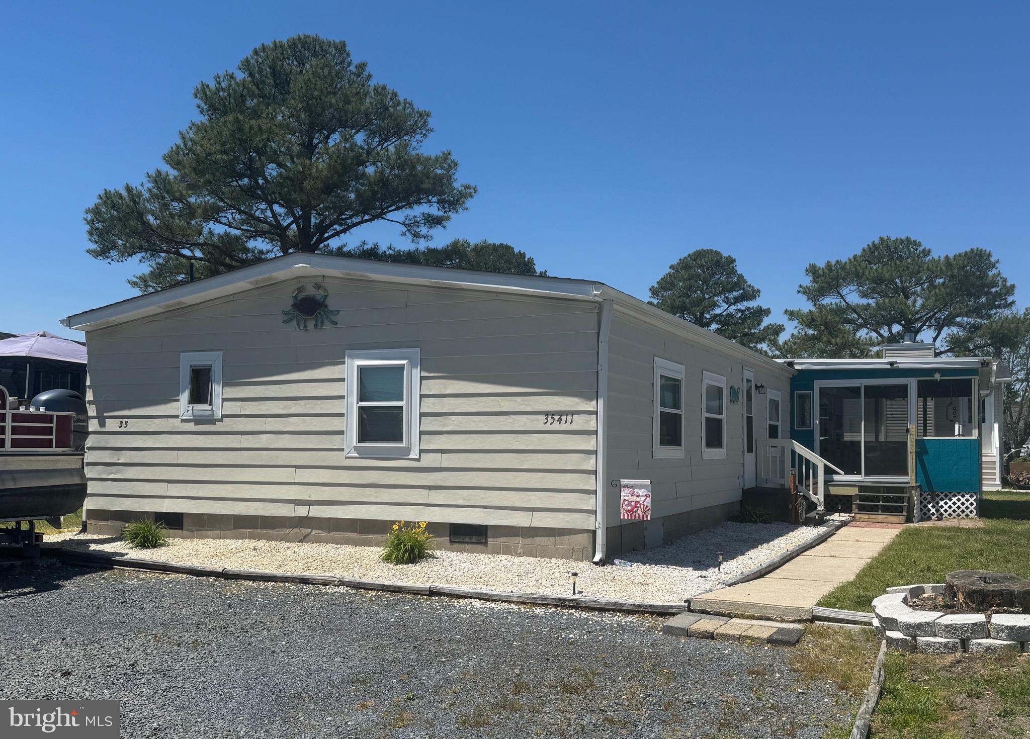 MOTIVATED Seller!!  Would you like to wake up each day looking at the water?  Then here you go! This spacious home is anxiously waiting for a loving new owner.  This Leased Land Community known as Mariners Cove is conveniently located to local restaurants/shopping and most definitely ideal for that avid boater or fisherman at heart. You are close to the popular Paradise Grill and approximately 14 miles to the Rehoboth Beach boardwalk.  Home has 2 bedrooms, 1 bathroom with dual sinks and a linen closet, large kitchen, small office space off the kitchen and a good-sized living area. There is a nice extension of the home off the kitchen creating a great gathering place for “game night” or "movie time".  And let’s not forget that HUGE screened in porch for your crab eating fest!    With a little TLC, some creativity and the footprint at hand, one could reconfigure the floor plan to one’s imagination. There is also a large shed for all your beach and fishing gear.  Home is being sold "AS IS" inspections are for informational purposes only.  The affordable monthly land rent of only $707.00 does include use of the pool, community center and golf carts are allowed. Schedule your  showing now!  Camera's in use on property.  An interested buyer would need to apply to the community and pass a credit/background check.  Closing costs will include ½ of the 3.75% DMV Transfer Fee, a closing agent fee of $400 and any other expenses associated with this home.