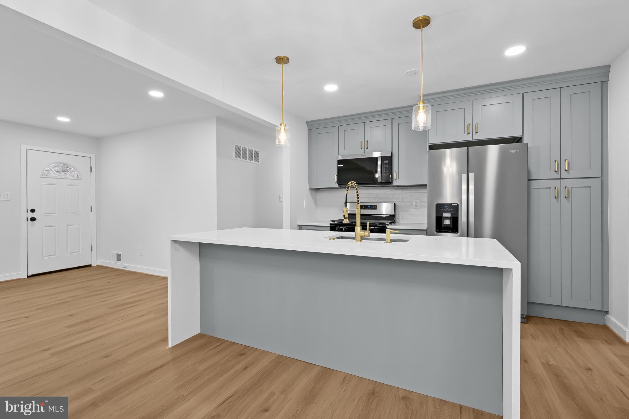 Step into this stylishly renovated 4-bedroom, 2.5-bathroom brick rambler offering nearly 1,900 square feet of thoughtfully designed living space in the well-connected Randolph Hills community of Rockville. The main level features a sun-filled open-concept layout with a spacious living room, a sleek modern kitchen with center island, stainless steel appliances, and soft gray cabinetry accented by elegant gold hardware. A dedicated dining area flows into a cozy family room—perfect for relaxing or entertaining.

Three bedrooms, including a spacious primary suite, share two beautifully updated bathrooms on this level.

Downstairs, the fully finished walkout basement offers exceptional flexibility, with a 600 sq ft recreation room, an oversized 4th bedroom, a full bathroom. 

Enjoy the outdoors in a fully fenced backyard with a concrete patio and low-maintenance landscaping. The asphalt driveway offers convenient off-street parking.

Located just 2 miles from Twinbrook Metro (Red Line) and 4.5 miles to Rockville Metro (Red Line, MARC, Amtrak), with bus stops under a mile away, this home provides outstanding commuter access.
Bonus: Just a few blocks from Rock Creek Park, residents enjoy trails, playgrounds, and scenic outdoor space right in the neighborhood.
