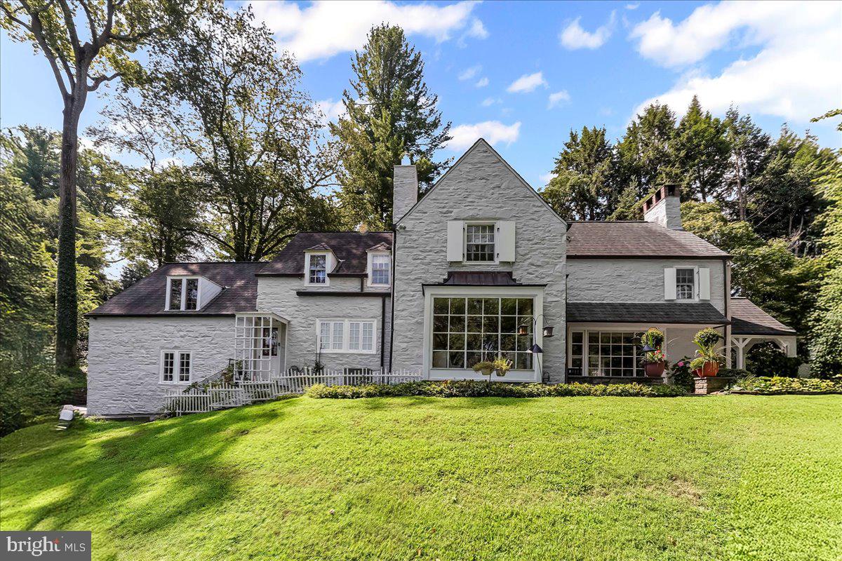 Elegant French Country Stone Home in Coveted Northside Bryn Mawr
Nestled on nearly an acre of lush, park-like grounds, this French Country–style stone residence blends timeless charm with modern comfort. Located on a quiet stretch of Old Gulph Road, yet just minutes from Bryn Mawr’s vibrant shops, restaurants, and train station, the home offers both privacy and convenience.

Inside, the foyer opens to a sun-filled living room with a wood-burning fireplace, bay window, built-in shelving, and random-width hardwood floors. French doors lead to a serene flagstone patio. The formal dining room, also with a bay window and patio access, is perfect for entertaining, while the den features custom bookshelves and a wet bar. The spacious eat-in kitchen boasts granite countertops, stainless steel appliances, a built-in refrigerator, and abundant cabinetry. A powder room completes the main level.

Upstairs, the expansive primary suite offers two full bathrooms (one with heated floors) and generous closet space. Four additional bedrooms—each with direct bathroom access—including a private guest/in-law/au pair suite with sitting area and full bath.

The finished lower level provides a large family room, a fifth full bath, a laundry area, and substantial storage or hobby space. Outdoors, enjoy landscaped gardens, open and covered patios, and a two-car attached garage.

This exceptional property combines space, character, and a premier location—an opportunity to own a gracious home in one of Bryn Mawr’s most sought-after neighborhoods.