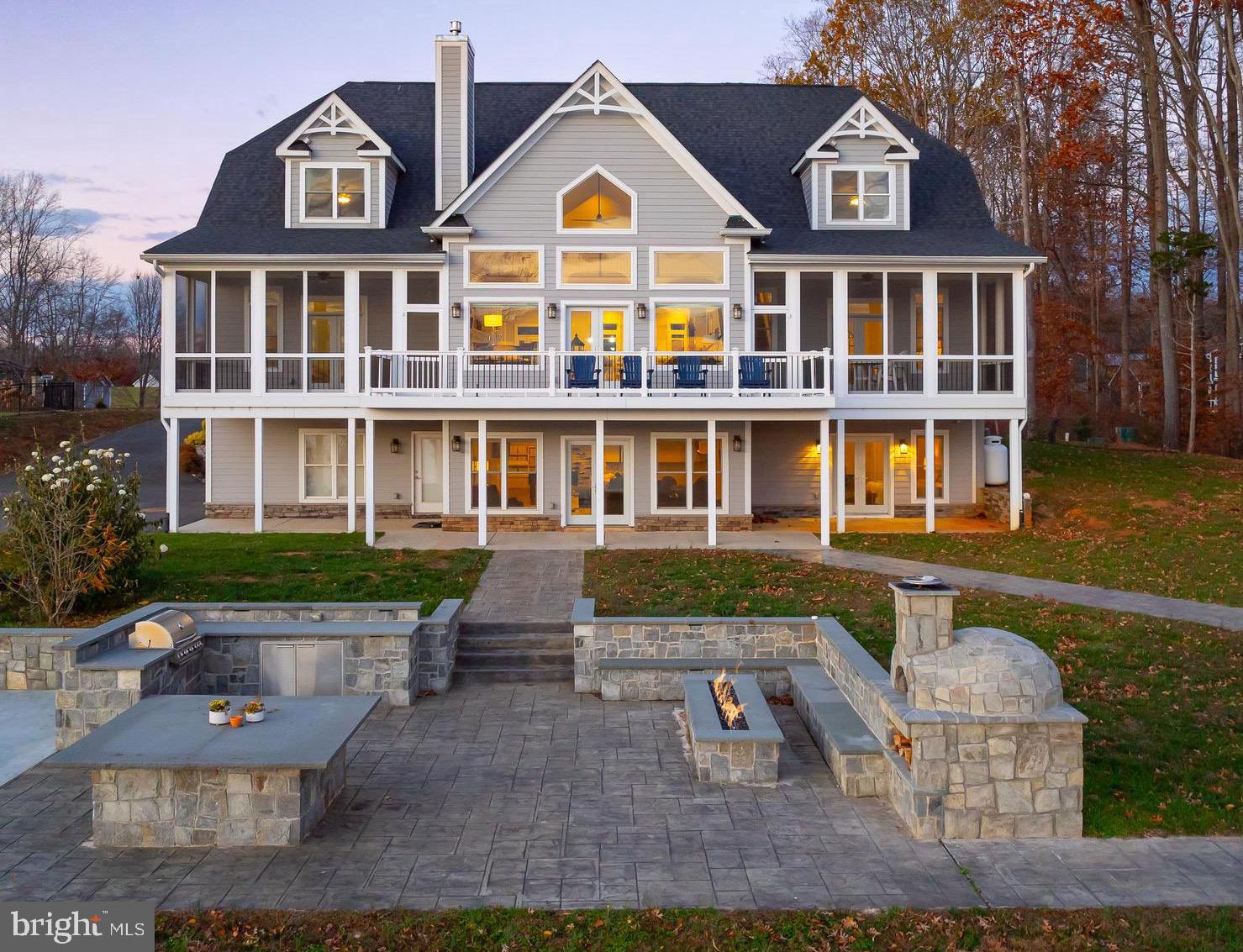 One of the most desirable and breathtaking waterfront properties ever seen at Lake Anna.  Recently constructed by the highly-skilled lake home builders at A&G Builders, this perfectly-situated lakeside fortress exudes luxurious perfection, and offers exceedingly rare water views, unlike any other at Lake Anna, including spectacular sunsets that will leave you speechless.  Enjoy massive interiors exceeding 6,700 square feet, where generous living spaces invite comfortable retreats, cozy afternoons, and grand entertaining.  The nearly 20-foot vaulted ceilings in the cavernous main living area are a tribute to the thoughtful design of this home, featuring floor-to-ceiling windows showcasing jaw-dropping water views of Lake Anna, a large warm  fireplace with mantle, gorgeous custom chair rail and picture frame trim throughout, and custom built-in shelving.  The spacious upgraded chef's kitchen with stainless appliances, quartz countertops, large island, coffee bar, and dining room are all seamlessly connected in this wide open space.  The large primary suite on the main level includes a private screened balcony overlooking the lake, sitting area, walk-in closet, custom built-in shelving, and large en suite bathroom with large tile soaking tub, a double vanity, and luxury tile shower.  Your guests will enjoy six additional bedrooms throughout the home, two of which are also on the first level.  Hitch a ride in the elevator up to the second level, where your family and friends can stretch out in two massive guest suites with tremendous water views, spacious window seats overlooking the lake, large en suite bathrooms, and an impressive loft overlooking the great room below and expansive water views of Lake Anna.  The enormous walkout basement offers a full kitchen and bar, another fireplace surrounded by custom built-ins, elevator, two additional large bedrooms - one featuring incredible custom built-in bunk beds -  a large full bathroom, additional laundry/storage room, and a large attached garage.  The large composite back deck is sure to impress with its million-dollar sunset views of the lake, while also overlooking the massive outdoor kitchen with elaborate stone hardscaping, wood-burning stone pizza kitchen, propane fire pit, wraparound stone countertops, stone seating benches, built-in propane grill, massive stone center table, and custom pickle ball court - all overlooking the lake.  The large boathouse sits on nearly 200 feet of unobstructed shoreline with natural sandy beach, and offers deep water (approximately 8 feet), a large screened-in porch, composite decking, bar with rollup door, sunbathing deck, and two boat slips with electric lifts for convenient boat and jet ski parking.  Investors: short term rentals are not only permitted here, but they also thrive at Lake Anna.  For this property, a top local property manager at Lake Anna generated a rental income forecast that predicts rental income exceeding $300,000 per year at this home (see documents section).  Lake Anna has been reported as one of the top-producing short term rental locations in the United States.  Most furnishings and decor can convey with purchase.