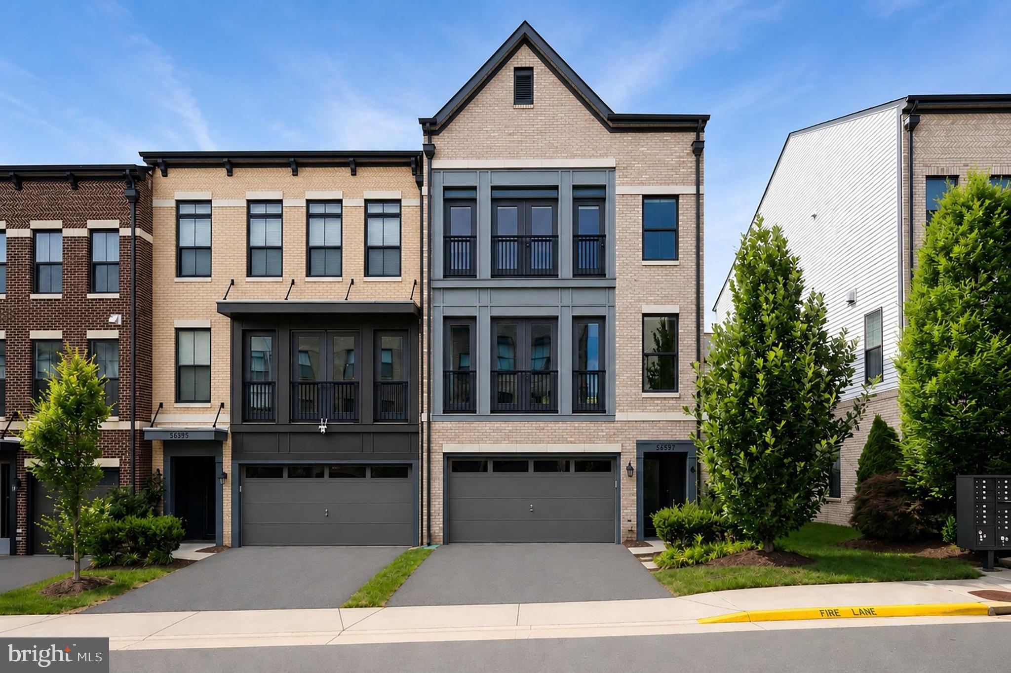 Stunning end-unit Parker model by Van Metre offering over 3,200 square feet of beautifully finished living space in the heart of Brambleton. This modern three-level townhome features 4 bedrooms, 3.5 bathrooms, a two-car front-load garage, driveway parking, and a fenced rear yard with a paver patio.
<br><br>
Designed for both everyday living and entertaining, the open-concept main level showcases engineered hardwood flooring, oak stairs with oak railings and iron spindles, and abundant natural light. The gourmet kitchen is the centerpiece of the home, featuring white cabinetry, steel gray granite countertops, stainless steel appliances, an oversized center island with seating, pendant lighting, an extended subway tile backsplash, and a walk-in pantry. The kitchen flows seamlessly into the breakfast area with access to the rear deck and opens to the spacious living room highlighted by a wall of custom built-ins.
<br><br>
The upper level continues with hardwood flooring and offers a spacious primary suite complete with a large walk-in closet and a luxurious bathroom featuring separate vanities and a walk-in shower. Two additional bedrooms are generously sized and share an updated hall bathroom. A conveniently located bedroom-level laundry room completes this floor.
<br><br>
The finished walk-out lower level provides exceptional flexibility with a recreation room, fourth bedroom, and full bathroom, making it ideal for guests, a home office, gym, or additional living space. Outdoor enjoyment awaits with a private fenced backyard, paver patio, and elevated deck.
<br><br>
Perfectly positioned within one of Loudoun County's most sought-after communities, Brambleton offers an unmatched lifestyle with multiple pools, parks, playgrounds, miles of walking and biking trails, community events, sports courts, and expansive green spaces. Residents enjoy convenient access to Brambleton Town Center's shopping, dining, entertainment, and everyday services. Commuters will appreciate the prime location near the Silver Line Metro, Dulles Airport, Route 267, Route 50, Route 28, and other major commuter routes. The home is also served by highly regarded Loudoun County schools, further enhancing the appeal of this exceptional offering.
<br><br>
Combining modern design, spacious living, outstanding community amenities, and an unbeatable location, this beautiful Van Metre Parker model presents an incredible opportunity to enjoy the very best of Brambleton living.