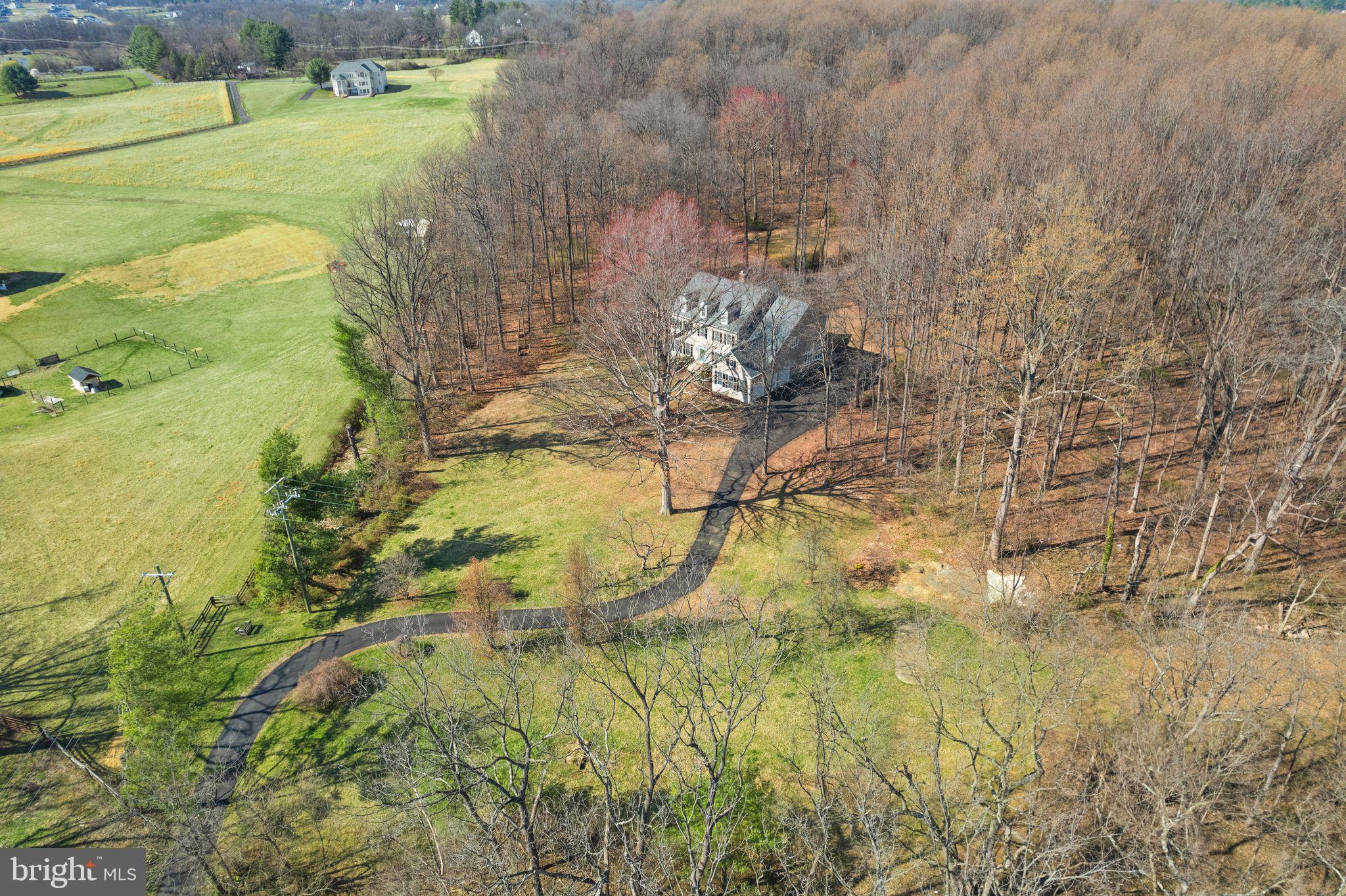 CHARMING COLONIAL HOME ON 11 ACRES! Welcome to this wonderful and well-maintained home, nestled on 11 private acres of open and wooded land in the heart of Western Loudoun County. Offering a perfect blend of seclusion and convenience, this property features no HOA (Zoned AR1), providing peace of mind and privacy. Despite its tranquility, you're just minutes from Route 7, local shopping, wineries, and breweries, offering easy access to everything you need. ** The home’s charming curb appeal, with low-maintenance vinyl siding and black shutters, welcomes you and your family! Inside, a grand two-story foyer with 10-foot ceilings creates a bright, open atmosphere from the moment you enter. Entertain in the spacious formal living and dining rooms, bathed in natural light. The main level also includes an office, ideal for remote work or study, and a well appointed family room featuring a wood-burning fireplace framed by stone, perfect for cozy evenings. The kitchen is a chef’s dream, with ample cabinetry and equipped with a  GE Monogram 48" built-in refrigerator, double ovens, granite countertops, a large island, and a pantry, offering ample space for cooking and entertaining. The breakfast area provides lovely views of the surrounding woods. A powder room, a convenient dog shower in the laundry room, along with a washer and dryer that convey, adds a practical touch to the home as well as a 3-car side entry garage. ** Upstairs, you'll find four spacious bedrooms, including the luxurious primary suite, a true retreat. The suite features a sitting room, spacious bedroom with tray ceiling and open views, two walk-in closets, and a spa-like bathroom with a large shower and a separate tub. Two additional bedrooms share a full bath, while a fourth bedroom offers its own private bath, providing flexibility and comfort for family or guests. The walk-up lower level is designed for both relaxation and entertainment. The large recreation room, with a wood stove, offers a cozy atmosphere. A wet bar, complete with a mini beverage cooler and dishwasher, makes hosting easy. Additional spaces include a bonus room and an exercise room, providing versatility for work, play, or relaxation. Outside, the property is a nature lover’s paradise. With easy access to the W&OD Trail, you can enjoy hiking or biking right from your door. The stone patio and nearby firepit create a peaceful outdoor retreat, surrounded by the beauty of the woods and the sounds of the local wildlife, including birds, and deer.  This home is equipped with a humidifier, dehumidifier, water softener, and a historic root cellar (as is), adding both comfort and character to the property. Updated HVAC systems and a new roof (replaced in 2023) ensure long-term efficiency and peace of mind. The entire home has just been painted on the interior and exterior and it's move in ready! This exceptional property offers the perfect balance of privacy, comfort, and access to nature, all while being just minutes from local conveniences. It’s a rare opportunity to own a home in one of Loudoun County’s most desirable locations.