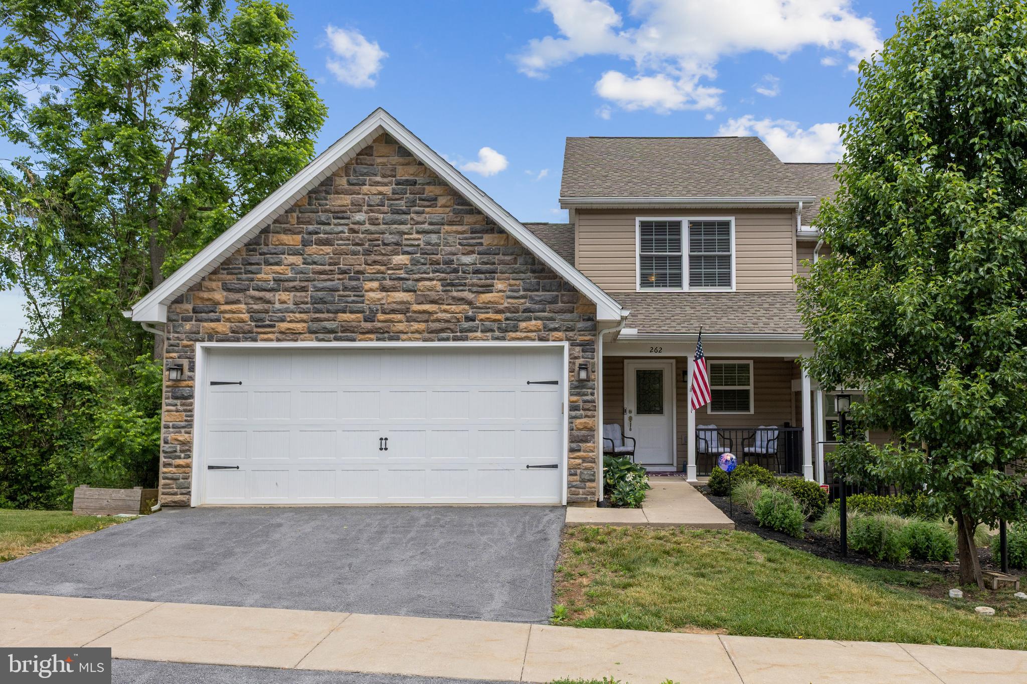 Tucked into the sought-after community of The Mews at Burnham Farms, this stunning townhouse delivers elegant finishes, modern upgrades, and a low-maintenance lifestyle- all just minutes from Penn State and the excitement of Happy Valley.

Inside, an open floor plan with vaulted ceilings, hardwood in the main living area, and an abundance of natural light sets a warm and welcoming tone. The gourmet kitchen impresses with ceiling-height white cabinetry, soft-close doors, a pantry unit, under-cabinet lighting, granite countertops, stainless steel gas appliances, and a large island. The living room centers around a corner gas fireplace with sliding doors opening to a deck with stunning views.

The coveted first-floor owner's suite offers a spacious walk-in closet and full bath. Two additional bedrooms and a full bath are found upstairs. The walk-out basement is a Penn State-themed entertainer's dream complete with high ceilings, LVP flooring, a kitchenette, and a gorgeous full bath perfect for recreation or guest quarters.

Enjoy a private, tree-lined end lot with breathtaking views. A low $115/month HOA fee covers lawn care, snow removal, and trash. Minutes to State College, I-99, shopping, and downtown Bellefonte.