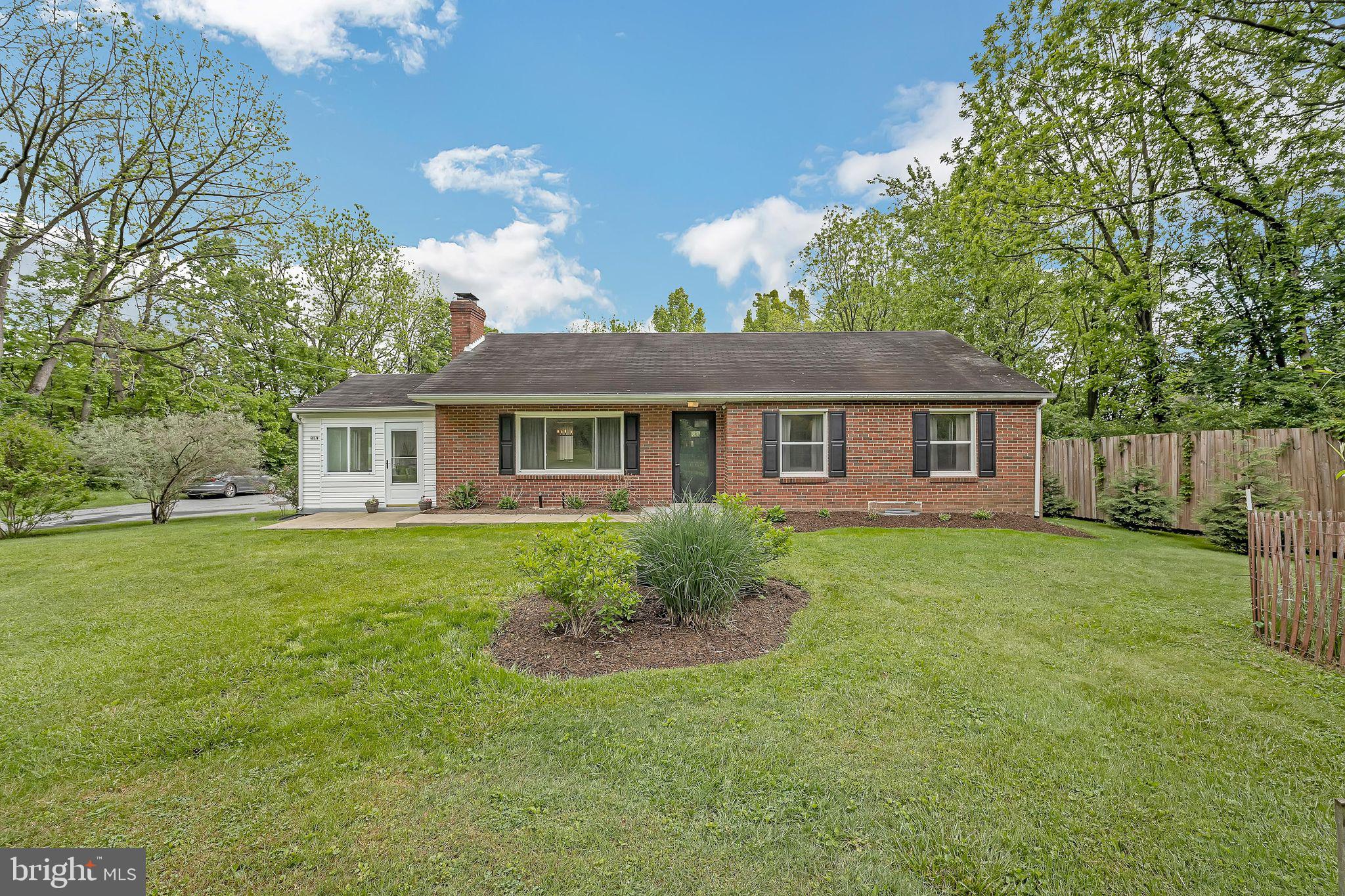Welcome to 6637A Mount Phillip Rd., where rural charm meets everyday convenience. Nestled on a spacious, tree-filled lot, this beautifully updated home offers peaceful living just minutes from all that Frederick has to offer. A welcoming front porch leads into a warm interior featuring rich plank flooring, upgraded fixtures, and a spacious living room with a cozy fireplace—perfect for relaxing or entertaining. The bright kitchen with granite countertops and a dining area flows beautifully into a sunroom that brings the outdoors in. The expansive primary bedroom—formerly two rooms—provides a true retreat. Downstairs, the fully finished basement offers even more living space with a bar, large rec room, bedroom, and full bath. A perfect blend of space, style, and location awaits!