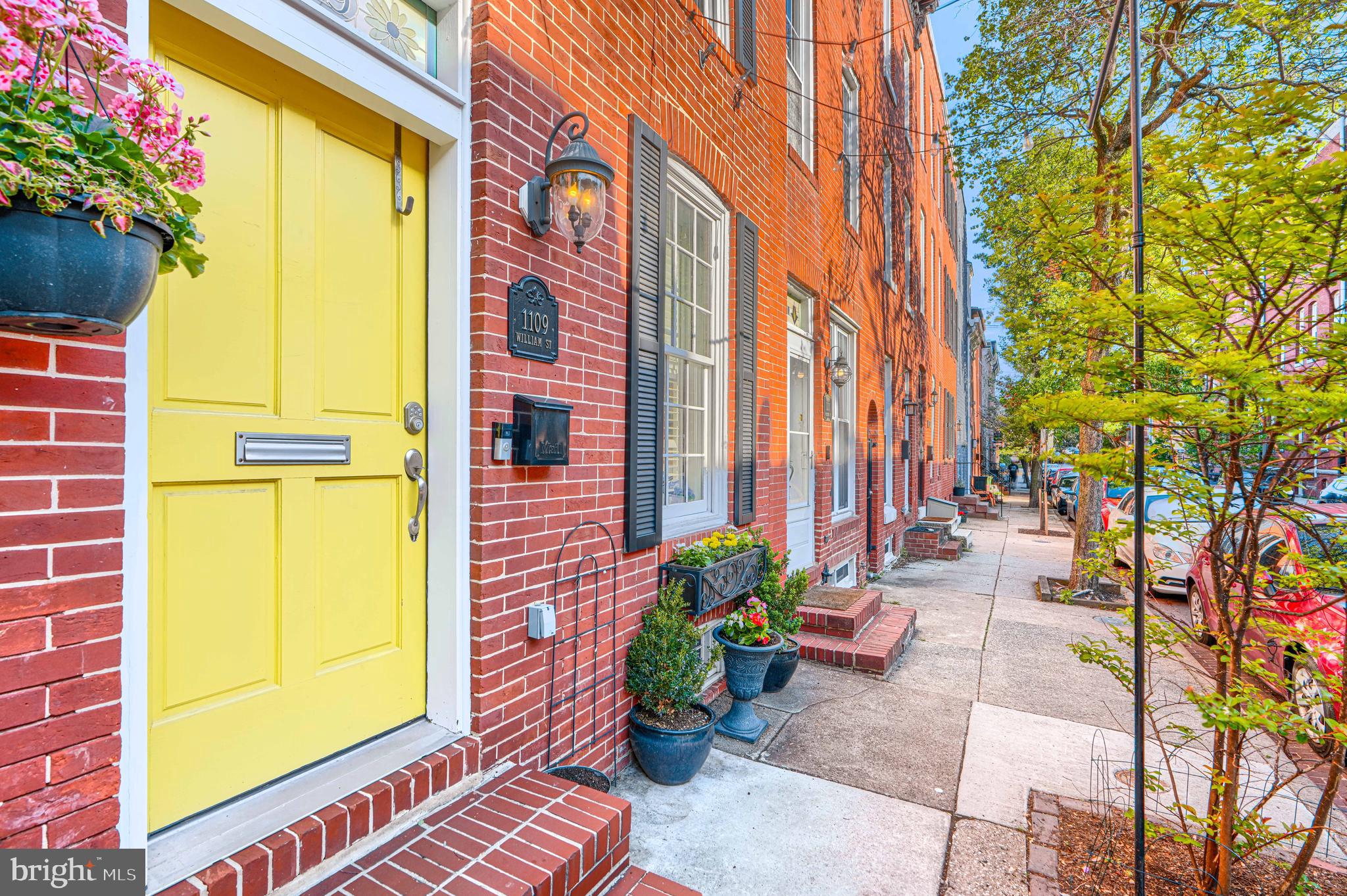 Once upon a time, tucked along one of Federal Hill’s most beloved streets, there was a house that didn’t just offer space, it offered a way of living.

From the moment you step inside, you feel it. Warm wood floors underfoot, exposed brick that tells the story of the home’s past, and custom millwork crafted by a local artisan that makes each room feel intentional and one of a kind. It’s the kind of detail you just don’t come across often. Full of character, full of personality, and quietly special in a way that’s hard to replicate.

The kitchen is where the house really opens up. Expanded and thoughtfully designed, it’s the kind of space that naturally becomes the heart of everything. A true chef’s kitchen, completely renovated in 2019, anchored by a built-in banquet that invites long dinners, slow mornings, and the kind of conversations that stretch late into the evening. Just beyond, custom shelving and a custom Baltimore mural add another layer of personality you won’t find anywhere else.

With nearly 3,500 square feet, the layout gives you room to live the way you want to. Four true bedrooms, plus a flexible space that easily becomes an office, studio, or playroom depending on the season of life you’re in. Each level feels purposeful, connected, and easy, with thoughtfully designed custom closet systems and storage solutions throughout that make everyday living feel effortless.

Upstairs, the third floor offers something special. A wet bar just inside makes entertaining on the rooftop effortless, whether it’s a quiet glass of wine at sunset or a full gathering under the city lights. Step out onto the two-tiered composite roof deck, newly built last year, and take in the views of the city and the stadiums. It’s one of those spaces that changes how you use your home.

And then there’s the unexpected. What was once parking for two cars has been transformed into a private enclosed courtyard with a parking pad behind it.  Tucked away and surprisingly peaceful, it’s perfect for a grill, a table, and a container garden that starts to feel like your own little secret garden. If you need another parking space, you can easily converted back. But once you experience it this way, you may not want to.

Behind the scenes, the big things have already been handled, including two new zoned HVAC systems installed in April 2022, the custom expanded gourmet kitchen added in 2019, a fully waterproofed basement completed in 2019, the stunning composite rooftop deck added in 2025, the enclosed courtyard created in 2019, outdoor shutters added in 2019, and closet organization systems added throughout.

And the location quietly seals it all. Just two blocks from the waterfront, where morning walks and evening strolls become part of your routine. Two blocks in the other direction brings you to the renovated and vibrant Cross Street Market, surrounded by some of the neighborhood’s best restaurants, shops, and everyday conveniences.

This isn’t just a house.
It’s the kind of place where life happens in all the best ways.