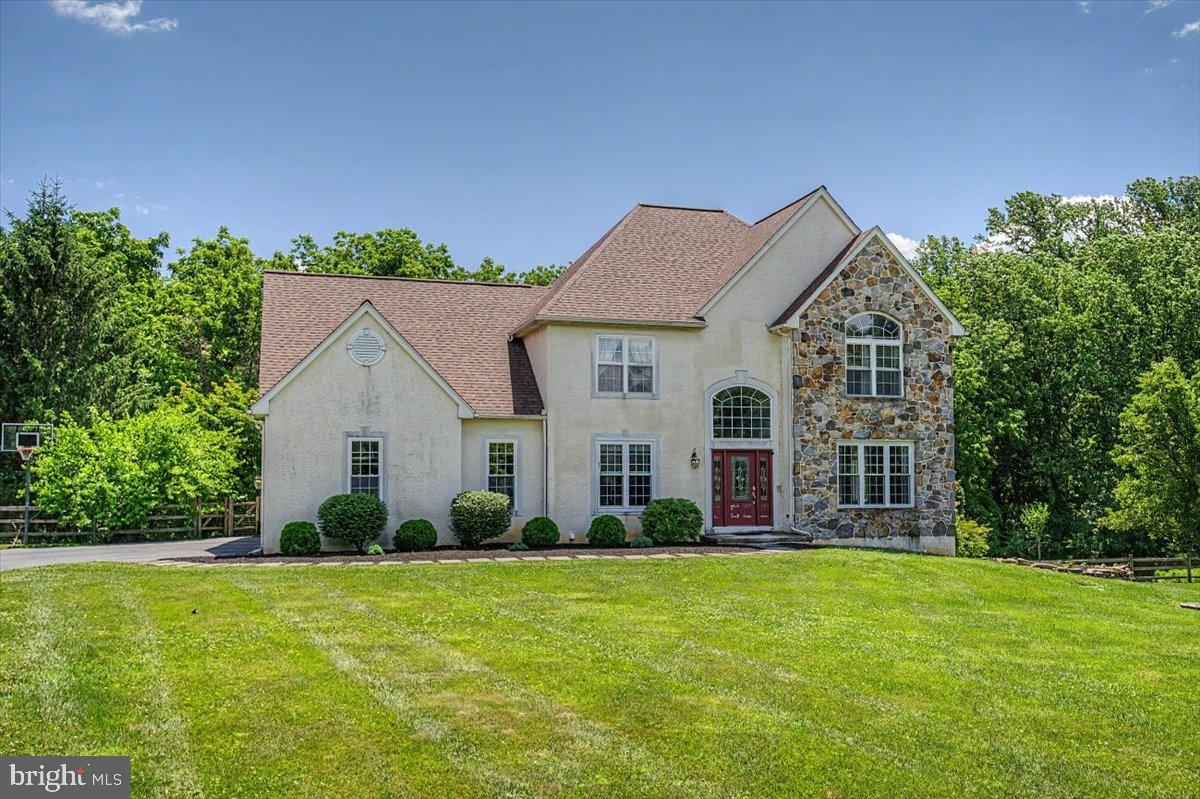Experience refined living in this 4-bedroom, 2.1-bathroom Colonial French-style home nestled in the delightful setting of Lincoln University, PA. This charming 2-story residence offers a vivacious blend of elegance and comfort with its thoroughly thought-out design. The home's layout is designed traditionally, featuring chair railings, crown moldings, and wainscotting throughout that add a touch of elegance and complexity in each room. As you step inside, you'll be greeted with an elegant two-story entrance that accesses both the living room with a wall of bookcases and the formal dining room with elegant wainscoting. Continue to the inviting kitchen and breakfast area boasting an island, custom cabinetry, stainless steel appliances, Corian counters and a pantry. Sliding glass doors lead to the Trex deck which overlooks the huge yard with large trees where you can enjoy the serenity of the surrounding area. The family room, conveniently situated off the kitchen, serves as a perfect sanctuary for relaxation, with the help of a vaulted ceiling, gas fireplace and a wall of windows to brighten your days. Wood flooring, LVT, and carpeting flow throughout the home, contributing to its warm and pleasant ambiance. Finishing the first floor is a computer nook off the living room, a half bath, and a first-floor laundry room. Retreat to the sizeable primary suite which includes a tray ceiling, a walk-in closet and a luxurious bathroom with double sinks, soaking tub and separate shower. Three additional & spacious bedrooms upstairs share another full bath. A highlight of the property is the walkout basement that is partially finished that is plumbed for an additional bathroom. This property is also equipped with a large, turned 3 car garage with an EVC (level 2) charging station, assuring ample space for your vehicles plus storage needs. Heating, AC, and water heater were all recently replaced! Uploaded with luxury features and in a sought-after location, this property is a standout option for those looking for a place to call home!