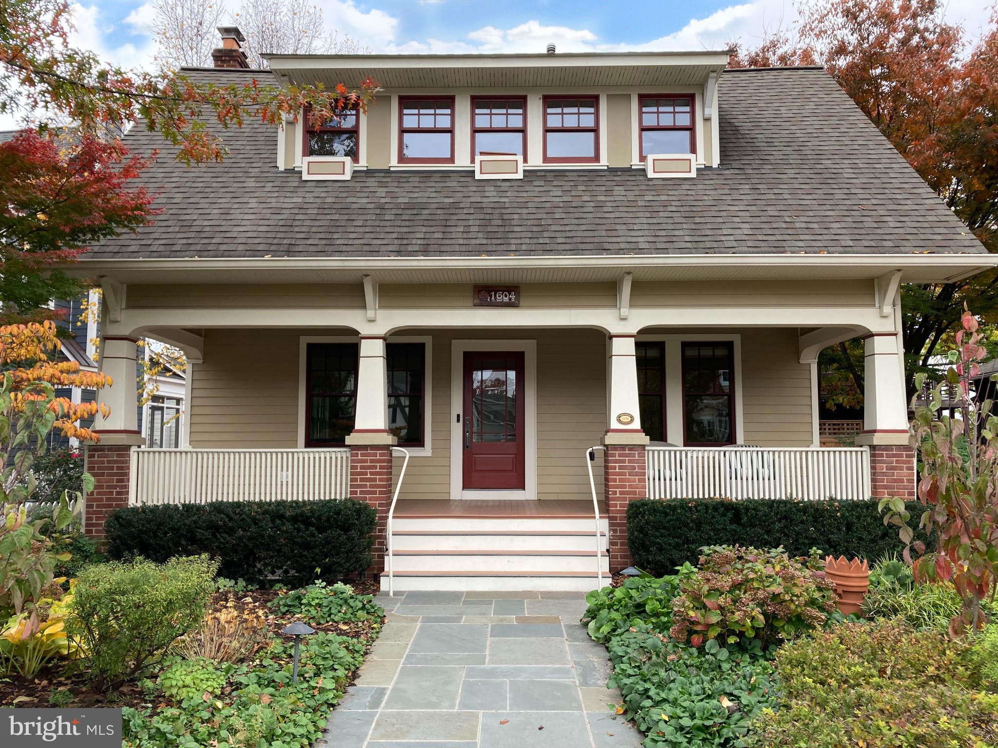 The spacious front porch beckons as you approach this classic Craftsman style home in historic Lyon Village. Imagine yourself reading the morning news or enjoying an evening with friends al fresco. Take note of the densely-landscaped front yard - no mowing needed - which is thoughtfully planted with dogwoods, hydrangeas, hostas, Solomon's seal and violets, infusing it with color across the growing seasons. 
 
Walking into this well-crafted residence is like stepping back in time, but with all of the modern conveniences. As you enter you immediately appreciate the open floor plan with a view that extends through to the rear of the house. The living room provides an intimate area to entertain, and the gas fireplace with custom tile surround is flanked by built-in bookcases. Just beyond is the light-filled, skylit dining room. A butler’s pantry includes a wine refrigerator and wet bar, and easily services both the front and rear of the home. The kitchen addition is spectacular with wide plank floors, custom cabinetry, Electrolux cooktop, double oven, refrigerator drawers, warming oven and Liebherr refrigerator. The breakfast bar with period-style pendant lighting separates the kitchen from the inviting family room. Two gracious sized bedrooms and a stunning full bath with custom mosaic tile in the shower and heated floors complete this level. 
 
On the second floor, you will appreciate the open concept at the top of the stairs, which can serve as a second family room and office area. Two bedrooms are located on this level. A large hall bath accesses a generous custom closet. The closet easily converts into a fifth bedroom. A small deck is your private sanctuary. And speaking of sanctuaries, you’ll love the primary suite. It is spacious and features a vaulted ceiling, two-way gas fireplace and wide plank floors. The primary bath includes a luxurious soaking tub, heated limestone floor, and separate steam shower with beautiful tilework. 

The walk-out lower level awaits your creativity offering opportunities for a finished playroom, office space, gym or extra storage - the possibilities are endless. And a half bath has already been added.
 
The rear garden patio is a peaceful retreat from the day’s activities. Climbing hydrangea, lenten rose, epimedium, eastern redbuds, crape myrtle and sweetbay magnolias accent a bluestone patio and enchanting koi pond with a bubbling fountain. A renovated one-car garage with custom doors and electricity is perfect for an extra vehicle or home and garden workshop.

This location has it all. You are minutes to downtown DC, Georgetown and the airport. Easy pedestrian access to both Courthouse and Clarendon metro stations make this a commuter's dream. Premier shopping and restaurants in Clarendon abound within five blocks of your front door. Walk to Whole Foods for a quick grocery run or head to Lyon Village Park for tennis, basketball, and a playground. This is a rare opportunity to own a fully-renovated home in an established community with prime access to the very best that our capital region offers.