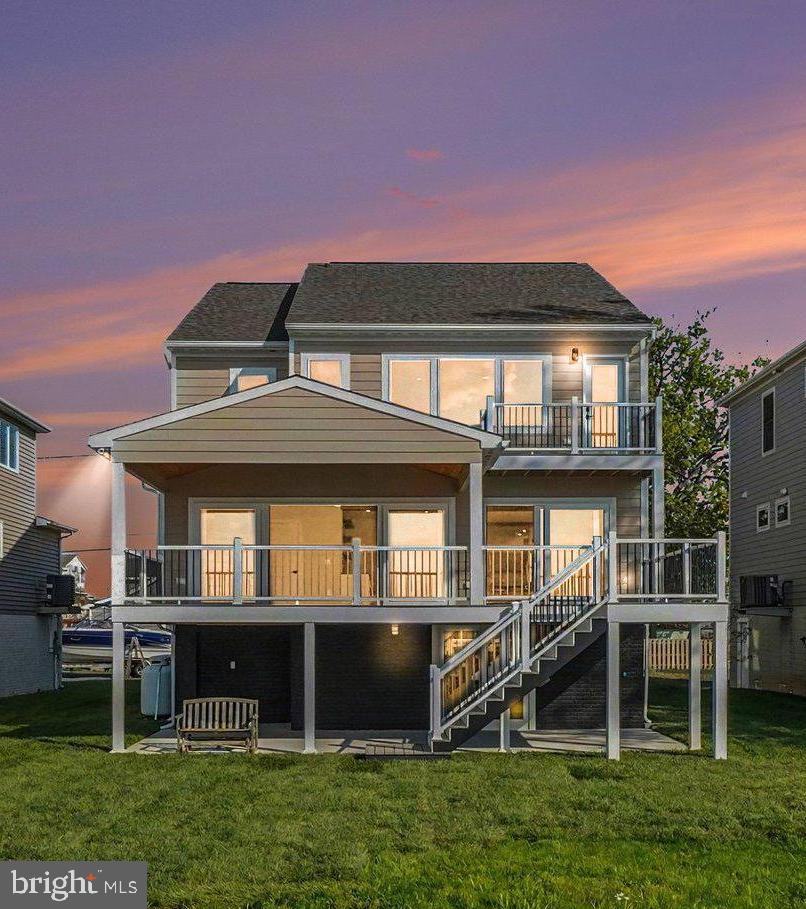 Waterfront home seekers now have a rare opportunity to own a superbly constructed 2" x 6" home offering 3,768 square feet of updated living and usable space. Recently renovated inside and out, this property features LP Smart siding and soffits, along with new windows and doors on every level, all enhanced with designer like finishes. Outside, enjoy a brand-new wooden bulkhead and an impressive 100-foot pier extending over the water—perfect for entertaining, relaxing, or simply taking in the peaceful sounds and sweeping views that stretch all the way to the Baltimore City skyline. This home offers two primary bedrooms, each with its own full bathroom—one conveniently located on the main level and the other on the upper level—ideal for guests or multi-generational living. Enjoy unobstructed, Key West-style sunset views that are nothing short of spectacular.  Located in the ever-popular 21219—known as “The Land of Pleasant Living” and “Where Life Imitates Vacation”—this home has been thoughtfully redesigned to embrace year-round waterfront living. Every day brings a new experience, from vibrant sunrises and radiant sunsets to wildlife, waterfowl, and glowing moonlit reflections across the water. Each season offers its own charm, from colorful springs and warm summers to serene winters and crisp autumns. Inside, the home features a pristine open floor plan with wood-look flooring throughout, abundant natural light, and a bright white kitchen complete with ample cabinetry, drawers, and many pull-out shelving units. The spacious great room showcases stunning 16'ft and 8'ft sliding doors that open to a 30' x 12' waterfront deck with a maintenance-free vinyl railing system—perfect for indoor-outdoor living.  Why deal with the challenges of new construction when this turnkey home is ready to enjoy? Waterfront inventory along the Baltimore County shoreline remains limited, especially for homes of this caliber. This property is ideal for year-round living or as a second home retreat. Enjoy crabbing, fishing, paddleboarding, kayaking, swimming, and boating right from your backyard, complete with a new 10,000 lb electric boat lift and dedicated PWC watercraft storage.  Conveniently located just minutes from North Point State Park and Sparrows Point SE Regional Park and Community Center, and only a short paddle to Pleasure Island and Hart-Miller Island, this home is a dream for outdoor and water enthusiasts. The Millers Island community offers a vibrant lifestyle with year-round events, including golf cart parades, tree lightings, chili and bake-off contests, 5K runs, holiday celebrations, pickleball, and more.  With easy access to I-695, I-95, Baltimore City, and BWI Airport, this location offers both tranquility and convenience. Skip the beach traffic and enjoy the waterfront lifestyle right here in Baltimore County. Whether you are downsizing, upsizing, or seeking the perfect getaway, this home offers an unmatched blend of comfort, lifestyle, and location. Live simply, beautifully, and create lasting memories in your own waterfront retreat. (Virtual Staging Disclosure) Certain photographs included in this property listing have been virtually staged for decorative and furniture layout purposes only. Buyers are encouraged to personally inspect the property to verify all features and existing conditions.