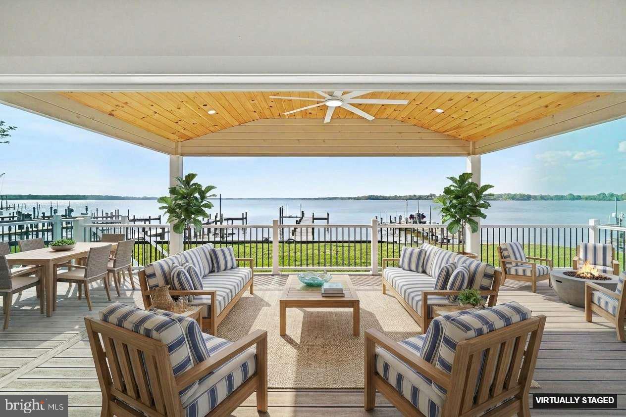 Waterfront home seekers now have a rare opportunity to own a superbly constructed 2" x 6" home offering 3,768 square feet of updated living and usable space. Recently renovated inside and out, this property features LP Smart siding and soffits, along with new windows and doors on every level, all enhanced with designer like finishes. Outside, enjoy a brand-new wooden bulkhead and an impressive 100-foot pier extending over the water—perfect for entertaining, relaxing, or simply taking in the peaceful sounds and sweeping views that stretch all the way to the Baltimore City skyline. This home offers two primary bedrooms, each with its own full bathroom—one conveniently located on the main level and the other on the upper level—ideal for guests or multi-generational living. Enjoy unobstructed, Key West-style sunset views that are nothing short of spectacular.  Located in the ever-popular 21219—known as “The Land of Pleasant Living” and “Where Life Imitates Vacation”—this home has been thoughtfully redesigned to embrace year-round waterfront living. Every day brings a new experience, from vibrant sunrises and radiant sunsets to wildlife, waterfowl, and glowing moonlit reflections across the water. Each season offers its own charm, from colorful springs and warm summers to serene winters and crisp autumns. Inside, the home features a pristine open floor plan with wood-look flooring throughout, abundant natural light, and a bright white kitchen complete with ample cabinetry, drawers, and many pull-out shelving units. The spacious great room showcases stunning 16'ft and 8'ft sliding doors that open to a 30' x 12' waterfront deck with a maintenance-free vinyl railing system—perfect for indoor-outdoor living.  Why deal with the challenges of new construction when this turnkey home is ready to enjoy? Waterfront inventory along the Baltimore County shoreline remains limited, especially for homes of this caliber. This property is ideal for year-round living or as a second home retreat. Enjoy crabbing, fishing, paddleboarding, kayaking, swimming, and boating right from your backyard, complete with a new 10,000 lb electric boat lift and dedicated PWC watercraft storage.  Conveniently located just minutes from North Point State Park and Sparrows Point SE Regional Park and Community Center, and only a short paddle to Pleasure Island and Hart-Miller Island, this home is a dream for outdoor and water enthusiasts. The Millers Island community offers a vibrant lifestyle with year-round events, including golf cart parades, tree lightings, chili and bake-off contests, 5K runs, holiday celebrations, pickleball, and more.  With easy access to I-695, I-95, Baltimore City, and BWI Airport, this location offers both tranquility and convenience. Skip the beach traffic and enjoy the waterfront lifestyle right here in Baltimore County. Whether you are downsizing, upsizing, or seeking the perfect getaway, this home offers an unmatched blend of comfort, lifestyle, and location. Live simply, beautifully, and create lasting memories in your own waterfront retreat. (Virtual Staging Disclosure) Certain photographs included in this property listing have been virtually staged for decorative and furniture layout purposes only. Buyers are encouraged to personally inspect the property to verify all features and existing conditions.