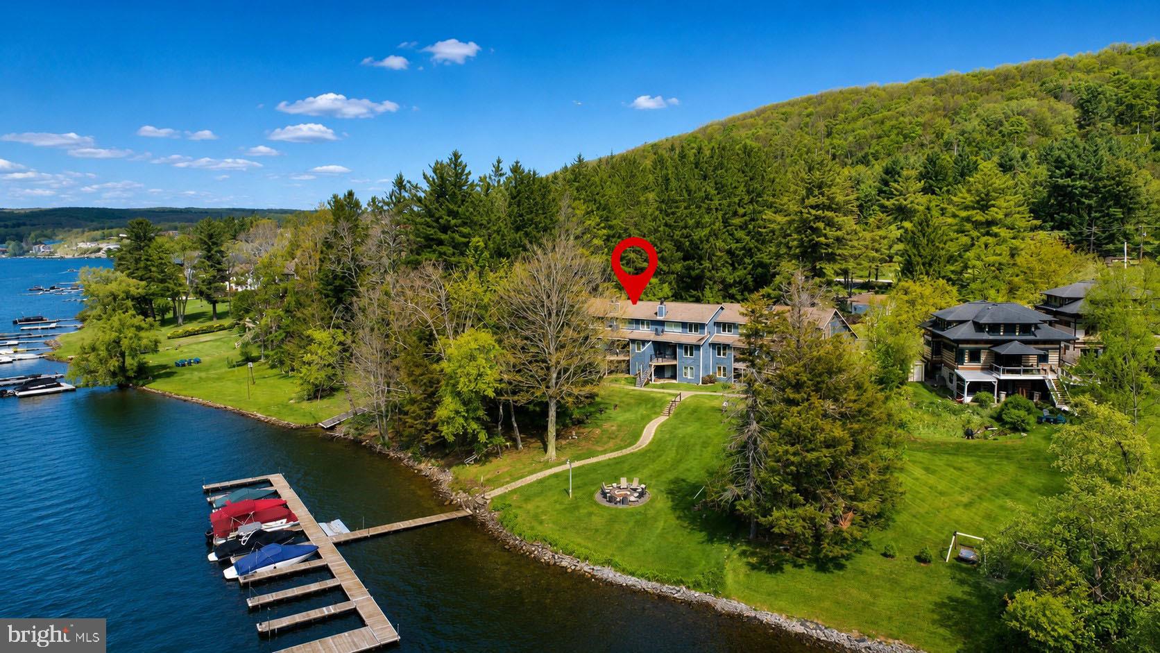 Tucked along the shores of Deep Creek Lake, this rare lakefront condo in the highly sought-after Pine Breeze community offers an opportunity that seldom comes available. Featuring 3 bedrooms, 3 full baths, and 2 levels of living space, this well-maintained retreat blends classic lake charm with thoughtful modern updates, including added A/C for year-round comfort. Enjoy the ease of level lakefront access, an assigned dock slip, and stunning lake views from your private lakeside deck — the perfect place for morning coffee or evenings by the water. Inside, the warm and inviting living area is highlighted by a wood-burning fireplace, creating the ideal mountain-lake atmosphere in every season. Pine Breeze has seen numerous community upgrades over the years, further enhancing the appeal of this established waterfront community. Whether you're searching for a personal getaway, full-time residence, or investment opportunity, this is your chance to own one of Deep Creek Lake’s hardest-to-find lakefront condo offerings.