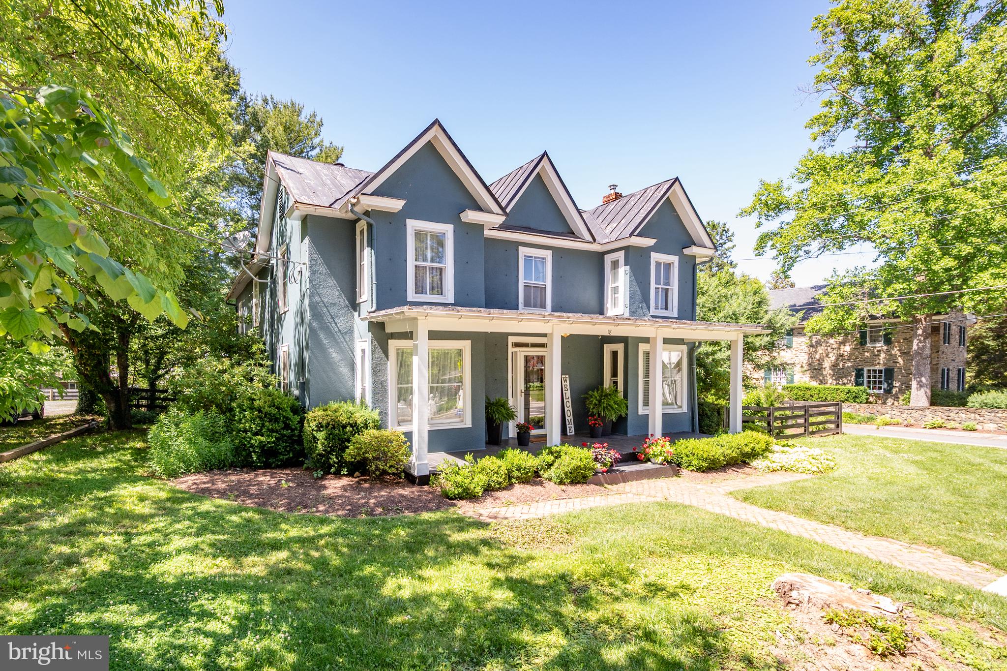 Authentic country with modern updates makes this home the real country house – many imitate. Updated with vision, and with full respect for the legacy of the home.  No HOA.

Since 1933, more than four generations lived, celebrated, and made their most important moments here. Step out of your front door and walk to coffee shop, restaurants, post office, and many small town amenities. The oversized detached garage and expansive driveway afford ample parking and storage. An ideal opportunity for car enthusiasts and hobbyists; for commuters looking for easy access; or for those exploring ADU potential for supplemental income. Large rooms and a main-level bedroom provide practical everyday livability. The home’s vintage character has been thoughtfully preserved while meaningful updates to the kitchen and baths bring elegance and convenience.

Wide-plank pine floors run through much of the home. Take a close look at their warmth. Beautiful moldings and built-ins attest to the home’s heritage.  The clawfoot cast iron tub has outlasted every design trend of the last century. 

The country kitchen delivers 21st Century quality with its farmhouse sink, granite counters, stainless steel topped island, and a full suite of GE Café appliances. 

The main-level bedroom can double as a private office, a guest suite, or even a gym. The sunroom, just off the kitchen is perfect for greeting dogs, children, and friends. Its wall of windows offers charming views of Round Hill’s best. It is a lovely place to enjoy a cup of coffee while working from home. 

6 Mini-split systems (heat pumps) deliver zoned comfort on your terms. Each space offers individual climate control - tuned to individual need without waste. The level fenced yard is private, shaded, and offers seasonal delights and colors. Enjoy grilling, entertaining or a glass of wine on the flagstone and brick terraces.  What could be better than enjoying a town parade from the luxury of your authentic front porch? Lovely trees and flowering shrubs embrace the grounds and define the architecture. Due to the age of the house, it is being sold As-Is.

The Town of Round Hill is a way of life.

Request your private tour today.