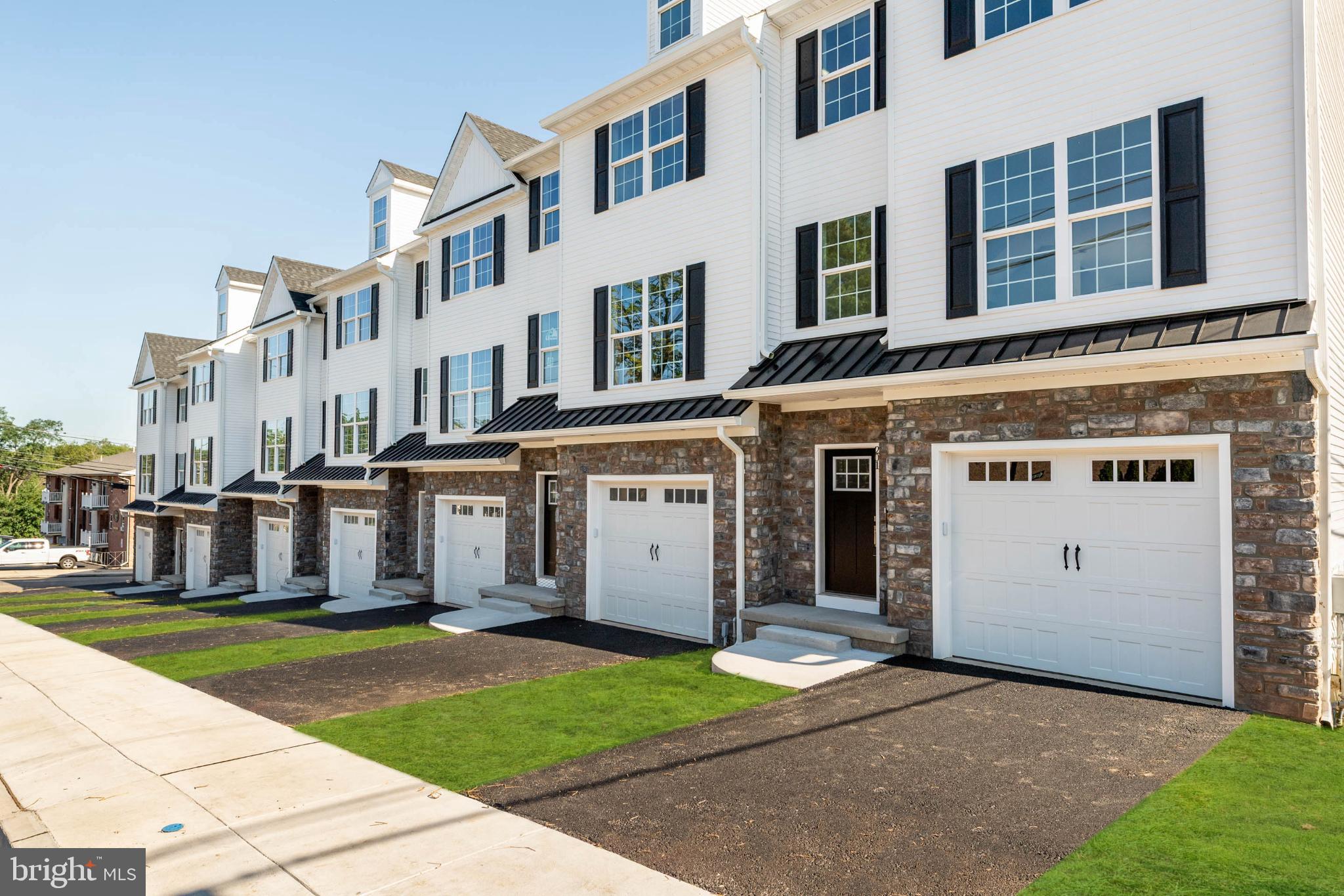Welcome to Bridgeview Crossing, a boutique townhome community featuring just seven exclusive residences, thoughtfully built by Vuotto Builders, a respected custom home builder known for quality craftsmanship and attention to detail. These beautifully designed homes offer spacious 3- and 4-bedroom floor plans, 2.5 bathrooms, and four levels of well-planned living space, combining modern luxury with everyday functionality. Enter from the covered front porch into a welcoming foyer with a coat closet, then continue into the open-concept main level featuring 9-foot ceilings, luxury vinyl flooring, recessed lighting, and abundant natural light. A convenient powder room and pantry enhance the layout without compromising style. The gourmet kitchen is the heart of the home, showcasing an impressive 8-foot island, 42-inch cabinetry, quartz countertops, and a full suite of GE stainless steel appliances. The kitchen flows seamlessly to your private Trex deck, ideal for entertaining or relaxing outdoors, with the added benefit of a backyard that can be fenced for additional privacy. Upstairs, the primary suite offers a peaceful retreat with a walk-in closet and a spa-inspired bathroom featuring dual vanities, tile flooring, and a walk-in shower with a semi-frameless glass door. A spacious second bedroom, full hall bath, linen closet, and a conveniently located laundry area complete this level. All bedrooms are wired for ceiling fans for added comfort and flexibility. The top floor features a third bedroom perfect for a guest suite, home office, or private retreat, along with a deep storage closet for added versatility. The finished lower level expands your living space and opens to a second Trex deck, creating even more room for outdoor entertaining. Additional highlights include direct access to a 1-car garage wired and ready for an EV charger, extra storage, and a private driveway. Located in the highly regarded Upper Merion School District, and just minutes from King of Prussia, Conshohocken, major commuter routes, shopping, dining, and recreation, Bridgeview Crossing delivers modern new-construction living, custom-builder quality, and exceptional convenience—all with no HOA fees.