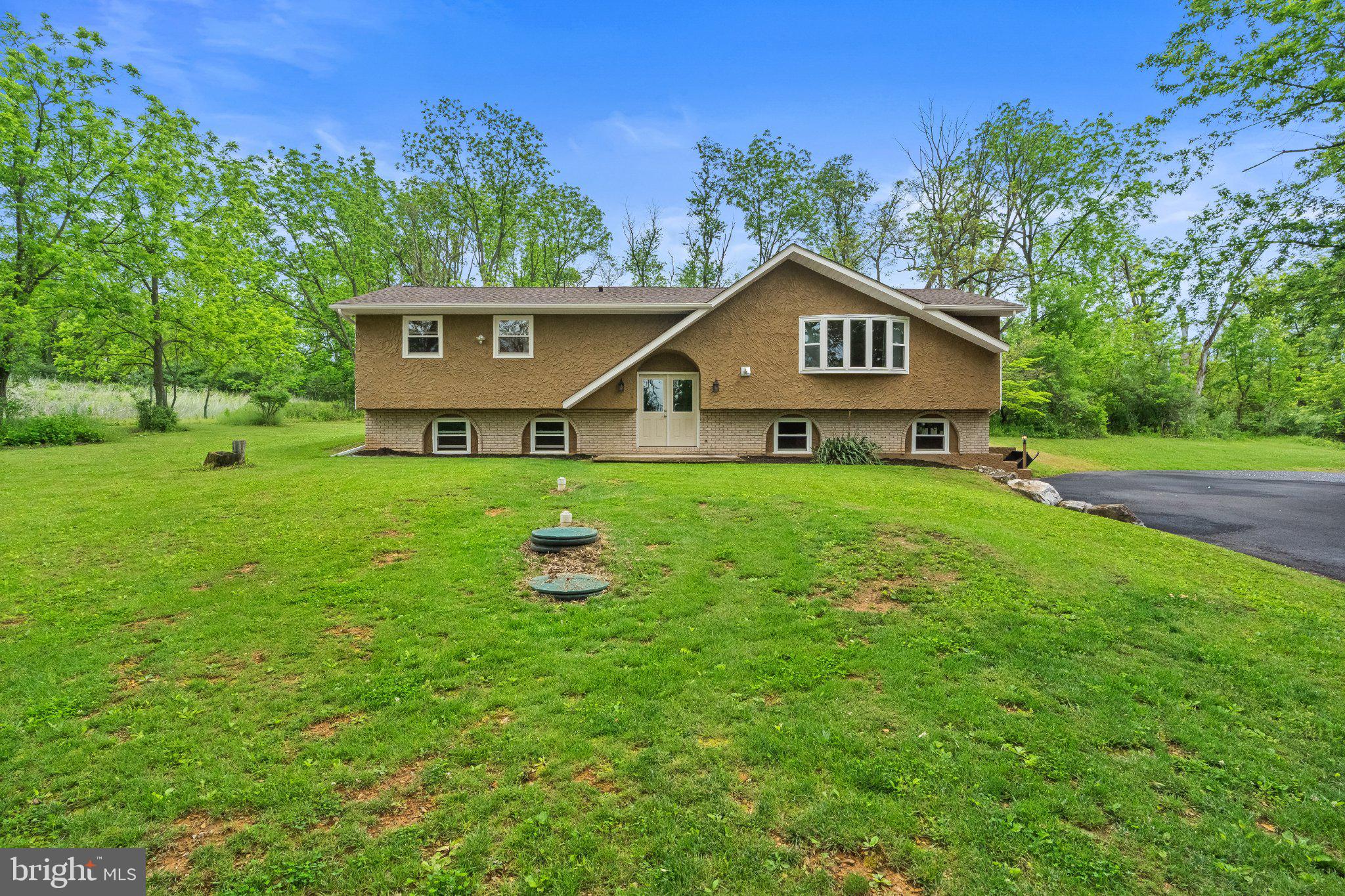 Welcome home to this totally remodeled home, updated from top to bottom! This beautiful 4-bedroom, 2.5-bath home is situated on a private 1.5-acre lot in Lehigh Township. The stunning remodeled kitchen features quartz countertops and KraftMaid cabinetry. All bathrooms have been completely updated with new vanities, mirrors, and lighting fixtures. Major upgrades include a new roof, new HVAC and central air system, all new windows and doors, new hot water heater, new flooring throughout, new vinyl siding, a new concrete patio, and a newly paved driveway extending from the road to the home. An oversized 20x30 two-car pole barn has also been newly installed. A pellet stove is included to help supplement heating costs during the colder months. New Septic Tank & Public Water. The lower level offers extended living quarters complete with a bedroom, kitchen, family room, office/playroom/exercise room, bathroom, and separate entrance — ideal for multi-generational living, guests, or additional living space. Enjoy relaxing on the backyard patio, surrounded by trees and the peaceful sounds of nature. Absolutely nothing to do but move right in — turnkey ready!