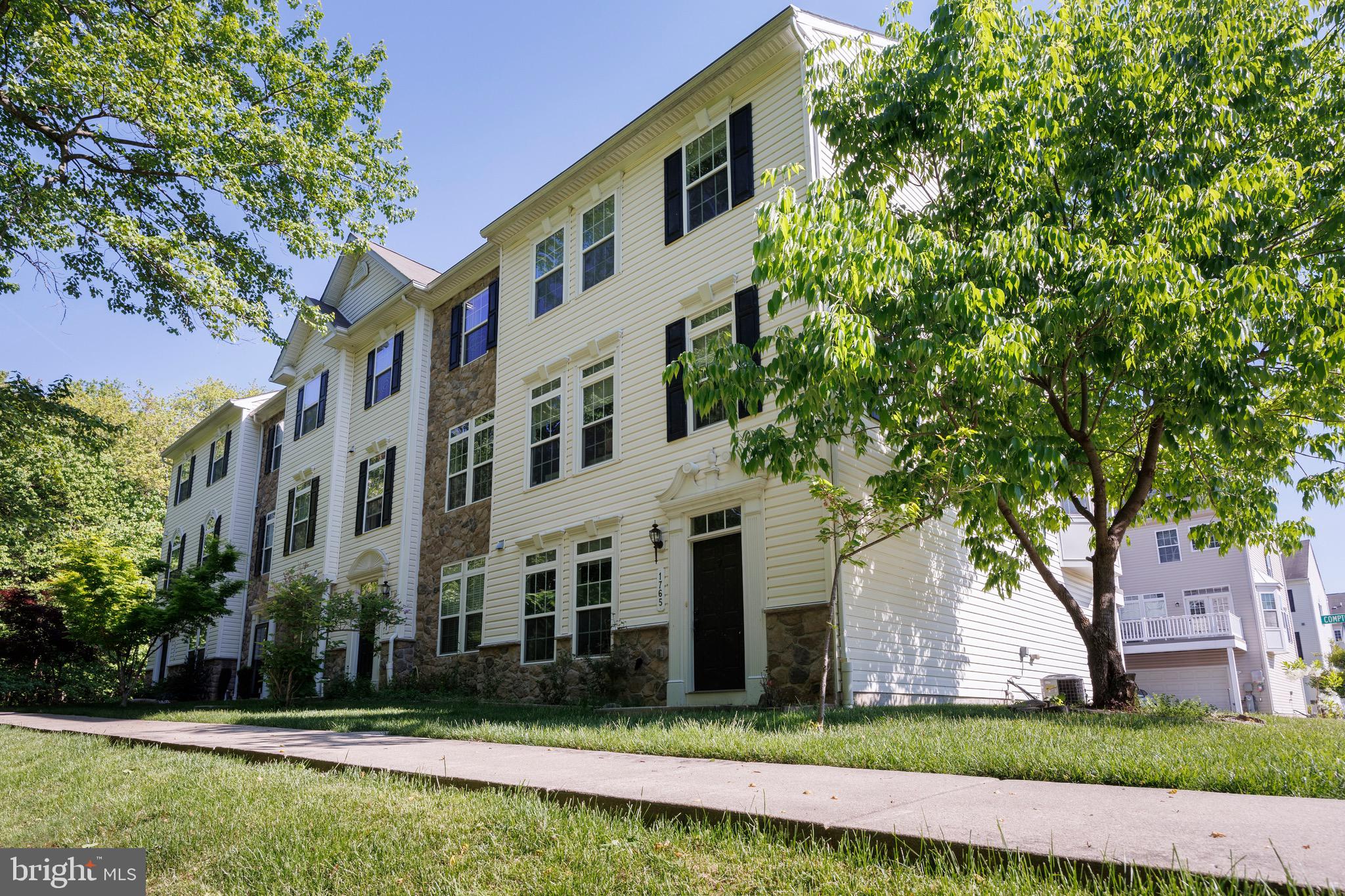 Welcome to this sun-filled end-unit Colonial townhome offering 3 bedrooms, 2.5 baths, and an ideal combination of comfort, convenience, and location. Situated on a premium lot facing a wooded area, this home enjoys abundant natural light and added privacy while providing easy access to a neighborhood street and nearby visitor parking. The spacious interior features bamboo flooring throughout the upper levels, tile flooring in the kitchen, and newly installed wood flooring in the entry-level office (2026). The open-concept kitchen includes stainless steel appliances, a large island, pantry, and adjoining dining area with access to the rear deck, perfect for everyday living and entertaining. The primary suite offers a walk-in closet, tray ceiling, and private bath, while two additional generously sized bedrooms share a full hall bath. The entry-level office provides flexible space for working from home, a library, or fitness area. Additional highlights include a two-car garage with electric vehicle charging, driveway parking, and plentiful guest parking nearby. Enjoy a highly walkable lifestyle with easy access to the community pool, playground, shopping, dining, Starbucks, urgent care, and more. Conveniently located near I-95, I-295, BWI Airport, Arundel Mills, Costco, and multiple grocery stores, making commuting and daily errands a breeze. Schedule your showing today!