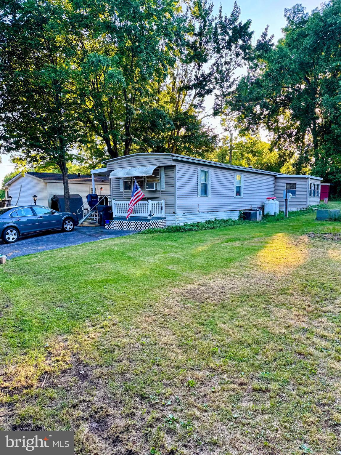 This well‑maintained 3‑bed, 1.5‑bath mobile home in Shippensburg Mobile Estates offers easy, economical living with updates throughout. An enclosed porch, deck, and add‑on space provide extra flexibility and room to spread out. With an HVAC system less than a year old and a chairlift included, this is a great opportunity to settle in comfortably and make this space your own.