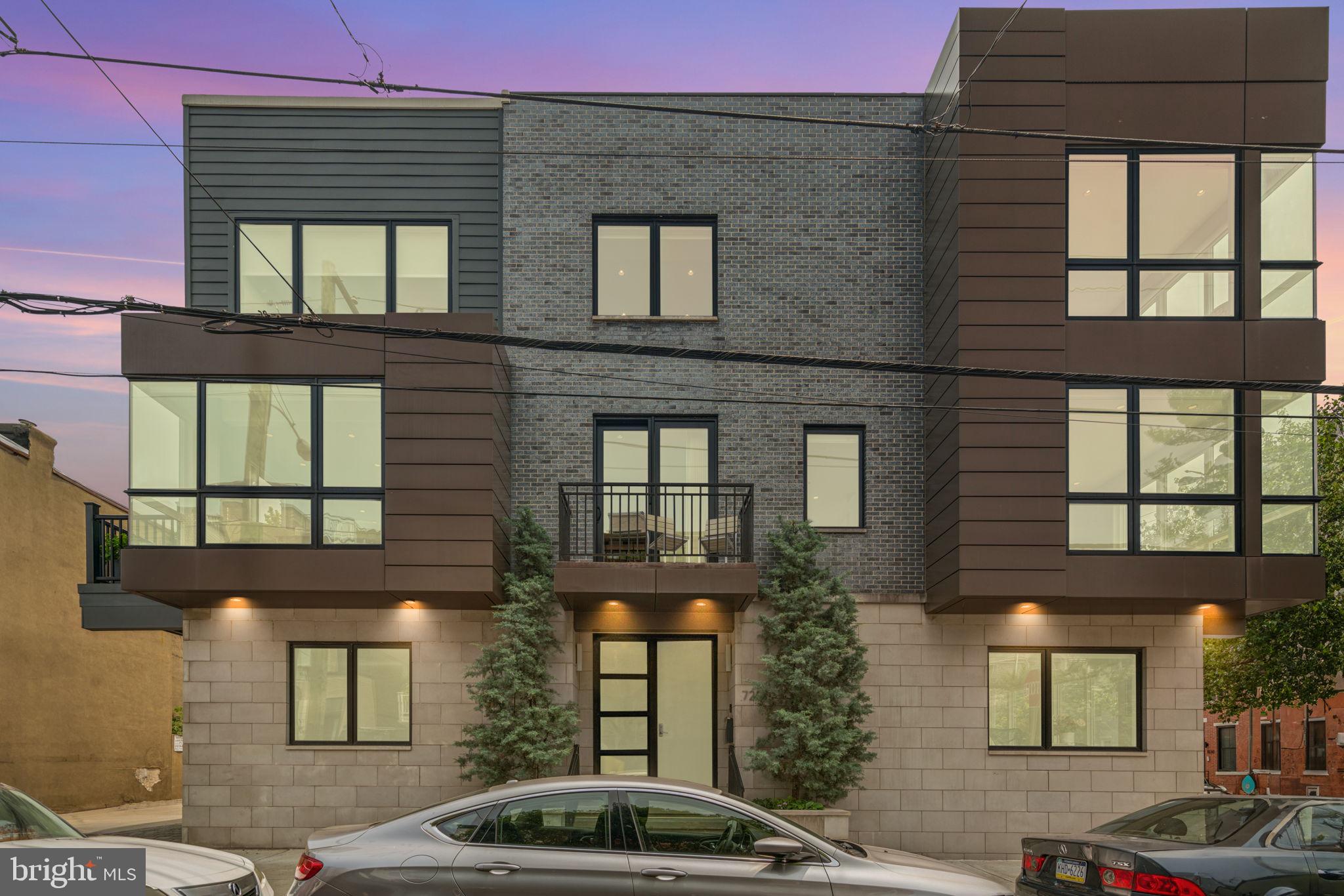 725 S 19th Street is a one-of-a-kind modern residence in the heart of Graduate Hospital offering 3 bedrooms, (4th BR easily added in finished lower level), 3 full bathrooms, 3,500+ sq ft of interior living space, and over 1,300 sq ft of outdoor space. Spanning the entire northeast corner of 19th & Fitzwater Streets, this extraordinary home stretches an impressive 71 feet wide—an almost unheard-of offering in Philadelphia. Also included is an oversized 2-car garage plus a driveway space for a total of 3-car parking.  Inside, a dramatic open steel & oak staircase connects sun-filled living and dining areas with a custom three-sided glass fireplace, and a chef’s kitchen with Wolf, Sub-Zero & Miele appliances, enormous stone island, and two outdoor terraces. The 3rd level includes the luxurious primary suite, and a  spa-like bath with soaking tub, triple-head double glass shower, and generous closets.  An expansively finished lower level has a custom wet bar, wine storage, laundry room and flexible space ideal for a home theater, gym, or family room—and can very easily accommodate a 4th bedroom.  At the top, a full pilot house with kitchenette opens to an expansive roof deck finished in porcelain pavers, offering true 360° panoramic views—river to river, sunrise to sunset, and the city skyline illuminated at night. All just blocks from Rittenhouse Square, Schuylkill River Park & Trails, and Center City’s best dining and culture.  Floorplan, video and detailed improvement list is available.