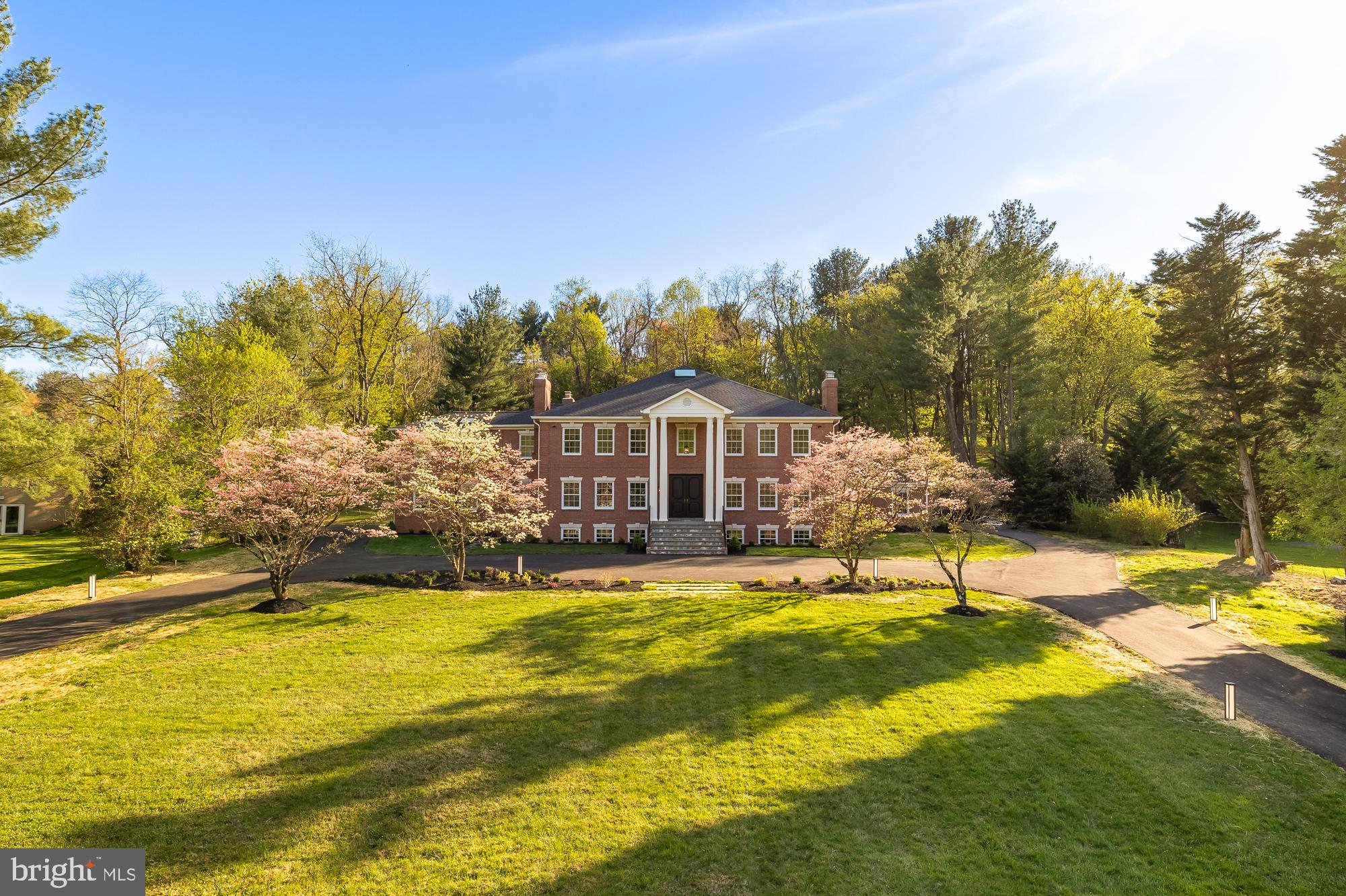 Set on two acres of landscaped grounds—masterfully designed by an award-winning landscape architect—this 9,000+ sq. ft. Georgian mansion seamlessly blends classic architecture with contemporary elegance.

Originally built in 1985 and completely renovated in 2025, this estate offers a rare combination of historical grandeur and modern luxury, with cutting-edge smart-home features integrated throughout.

The expansive outdoor setting includes a grand front lawn with a long circular driveway lined with trees, a stone fireplace and patio surrounded by flowering plants that sit as the centerpiece for the rear yard, and an additional inviting fire pit getaway perched up above the roof line for fantastic views. The expansive rear yard is thoughtfully designed to accommodate a future pool—an entertainer's dream.

Inside, the home is all about details and amenities, with every room thoughtfully curated for a discerning buyer. It exemplifies class and elegance with ornate moldings, handpicked imported lighting fixtures, and a functional layout. The estate features 6 bedrooms, 5 full bathrooms, 1 powder room, and 5 wood-burning fireplaces, creating an atmosphere of warmth and timeless charm.

The fully reimagined kitchen is a showpiece, boasting custom German-imported cabinetry complemented by Taj Mahal quartzite countertops, a butler’s pantry, and a separate back-of-house kitchen ideal for entertaining at scale.

A stunning main-level study is wrapped in rich navy Farrow & Ball paint and includes a custom wet bar with handmade brass/glass shelving and a unique one-of-a-kind colorful quartzite top—equally suited for work, leisure, or entertaining.

The luxurious 1,500-sq.-ft. primary suite includes a private sitting room or office, a fireplace, dual walk-in closets, and a spa-quality bath with radiant heat floors and an oversized steam shower.

The walk-out lower level is filled with natural light and offers a large rec room with a fireplace, a guest bedroom with separate entrance and patio, a home gym, and a wine cellar with room for over 1,000 bottles.

Conveniently located within walking distance to Potomac Village, top-ranked public and private schools, and just minutes from downtown Bethesda and D.C., this timeless estate is ready for its next chapter.