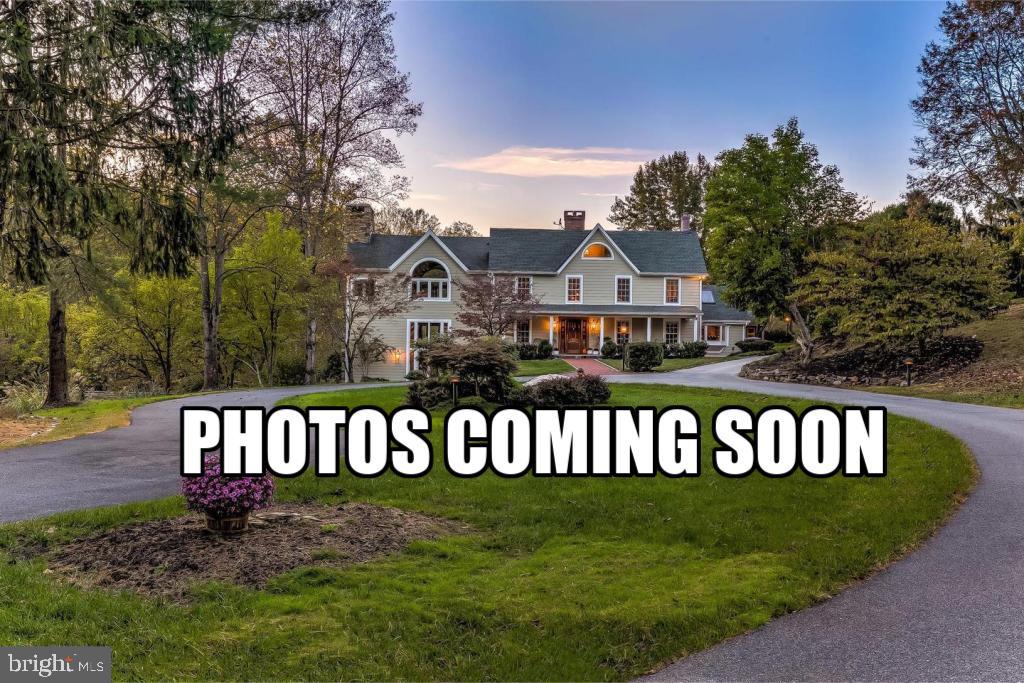 COMING SOON!

Beyond a private stone-gated entrance and a winding tree-lined drive lies one of Baltimore County's most extraordinary legacy estates. Encompassing more than 61 breathtaking acres bordering the Liberty Reservoir Preserve, this remarkable property offers an unmatched combination of architectural significance, natural beauty, and modern comfort. Rolling pastures, mature woodlands, tranquil ponds, a picturesque stream, and miles of protected scenery create a setting that feels worlds away, yet is conveniently located within easy reach of Hunt Valley, downtown Baltimore, and BWI Airport.

At the center of the estate is a spectacular residence offering more than 8,000 square feet of thoughtfully renovated living space. Originally designed in the timeless tradition of post-and-beam architecture, the home masterfully blends rustic character with contemporary elegance. Original stonework, vintage chestnut beams, soaring vaulted and cathedral ceilings, dramatic floor-to-ceiling windows, and handcrafted architectural details define the home's distinctive personality. A magnificent central stone hearth and chimney anchors the living spaces, while three impressive stone fireplaces add warmth, texture, and timeless charm throughout the home. The thoughtful balance of expansive open gathering areas and intimate living spaces creates an atmosphere that is both grand in scale and exceptionally welcoming, with natural light pouring into every room and spectacular views framing the landscape beyond.

The heart of the home is an exceptional gourmet country kitchen designed for both everyday living and effortless entertaining. Outfitted with Premium stainless steel appliances, generous island seating, custom cabinetry, and abundant prep space, the kitchen flows seamlessly into inviting family and dining areas. A butler's pantry, wet bar, and multiple entertaining spaces provide the perfect backdrop for intimate gatherings or large celebrations, while the adjacent screened porch offers a peaceful place to relax overlooking the resort-style pool, tennis court, and beautifully landscaped grounds.

The luxurious primary suite serves as a private retreat, complete with its own balcony overlooking the ponds, pastures, and surrounding forest. Spacious secondary bedrooms, beautifully updated baths, flexible living areas, and a convenient main-level guest suite provide exceptional comfort for family and visitors alike. A charming guest cottage with its own bedroom and full bath offers additional accommodations for extended family, guests, or a private home office.

Designed to embrace an active lifestyle, the estate offers an extraordinary collection of amenities rarely found on a single property. An in-ground swimming pool, lighted tennis court, extensive patios and porches, mature gardens, and beautifully crafted hardscaping create exceptional outdoor living spaces. Equestrian facilities include nearly 20 acres of fenced pasture, multiple run-in sheds with water and electric, a beautifully constructed four-stall post-and-beam bank barn, horse trails, and additional farm buildings. A substantial pole barn with concrete flooring and drainage, detached garages with space for multiple vehicles, and numerous outbuildings provide endless possibilities for collectors, hobbyists, agricultural pursuits, or recreational equipment.

Backing directly to thousands of protected acres of the Liberty Reservoir Preserve, this exceptional property offers immediate access to hiking, horseback riding, fishing, birdwatching, and abundant wildlife right beyond your own backyard. Whether envisioned as a private family estate, an equestrian sanctuary, a weekend retreat, or an entertainer's paradise, this is a property that offers a lifestyle few will ever experience.

Rarely does an estate combine such remarkable architecture, extraordinary privacy, and unparalleled natural surroundings with modern conveniences, including fiber optic internet, a whole-house gener