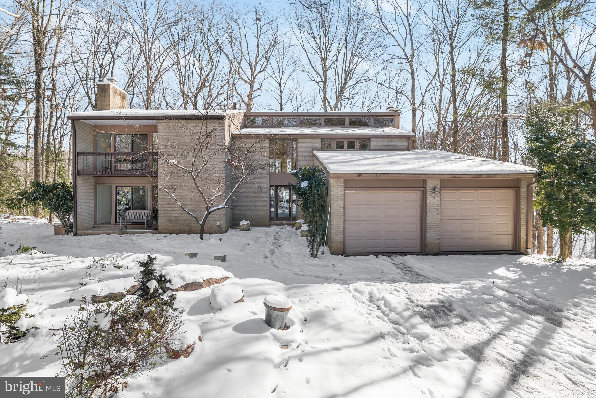 Nestled on nearly half an acre in a private East Gate of Potomac cul-de-sac resides 10501 Streamview Court, a stunning Midcentury Modern style home. Backing to the beautiful greenery of the neighboring Parkland, this pristinely remodeled residence boasts the serenity of suburban living while sited in close proximity to Potomac’s envious shopping, dining, and entertainment destinations. Inside, soaring 2-story and cathedral ceilings are accented by radiant natural light through walls of floor-to-ceiling windows, highlighting the 3 level, 5,283 square foot Contemporary’s incredible scale. Presenting an exquisitely executed open concept floor plan, tranquil views of the rear yard and the parkland’s bountiful greenery are enjoyed from the 5 Bedroom, 4.5 Bathroom abode’s gracious entertaining spaces to its magnificent private suites. The same serene views are effortlessly on display from the home’s expansive Rear Deck, offering the perfect setting for idyllic alfresco dining with its built-in bench seating. Boasting beautiful renovations to include a remodeled Gourmet Kitchen, newly renovated Bathrooms, Recreation Room and newly installed Lower Level Kitchenette, gleaming hardwood floors and updated windows throughout, this Contemporary residence is a rare gem just waiting to be discovered.
A modern glass entry door opens to the home’s grand 2-story Foyer, lending a warm welcome to the Main Level’s sprawling entertaining spaces. Hosting a seamless synthesis of formal and informal gathering spaces, the Main Level boasts a stunning Living Room adorned with a slate surround wood-burning fireplace, elegant Dining Room accented by cathedral natural wood ceilings and 2-story floor-to-ceiling windows, cozy Family Room complete with a stone surround wood-burning fireplace, and a sizable home Office featuring built-in bookcases and cabinetry. The remodeled Gourmet Kitchen is sure to delight any caliber chef with its gorgeous open concept layout, modern cabinetry, granite and butcher block counters, breakfast bar, Stainless Steel appliances, a coffee bar, pantry, and additional storage space. The large rear Deck provides a seamless transition to outdoor entertainment or a tranquil setting to enjoy your morning coffee. A newly renovated Powder Room, Laundry/Mud Room, and access to the attached 2-Car Garage complete the Main Level’s ample amenities.
Ascending the modern cable railed stairway, the Upper Level boasts a private principal suite, a virtual Owner’s oasis. Showcasing natural wood cathedral ceilings, walls of windows, a dressing area, ample closet space and a Sitting Room, the Primary Suite is a true respite within the residence. The luxurious sanctuary extends to the newly remodeled Primary Bathroom featuring cathedral ceilings, a walk-in shower and modern vanity. One of the level’s 3 additional Bedrooms boasts access to the private front-facing balcony, a walk-in closet and an ensuite Bathroom. An additional Hall Bathroom completes the Upper Level’s offerings.
Descending the hardwood stairway to the Lower Level, a newly remodeled and multifunctional In-Law style suite awaits. Spanning an extensive Recreation Room with access to the private Patio, a newly installed Kitchenette with a full-size refrigerator, granite counters, electric cooktop, microwave, and more, a fifth Bedroom, Full Bathroom and convenient Laundry Closet, your guests will feel right at home in this privately appointed suite. A large unfinished space offers plentiful storage and utility space or the opportunity to transform and extend the finished In-Law Suite. This exceptional residence offers one of the largest, most private lots in the neighborhood, access to the Buck Branch Park, tennis courts and Tally-Ho Swim Club at the end of the street, and proximity to Bells Mill Elementary, Cabin John Middle and Churchill High Schools, making it perfection for new owners!