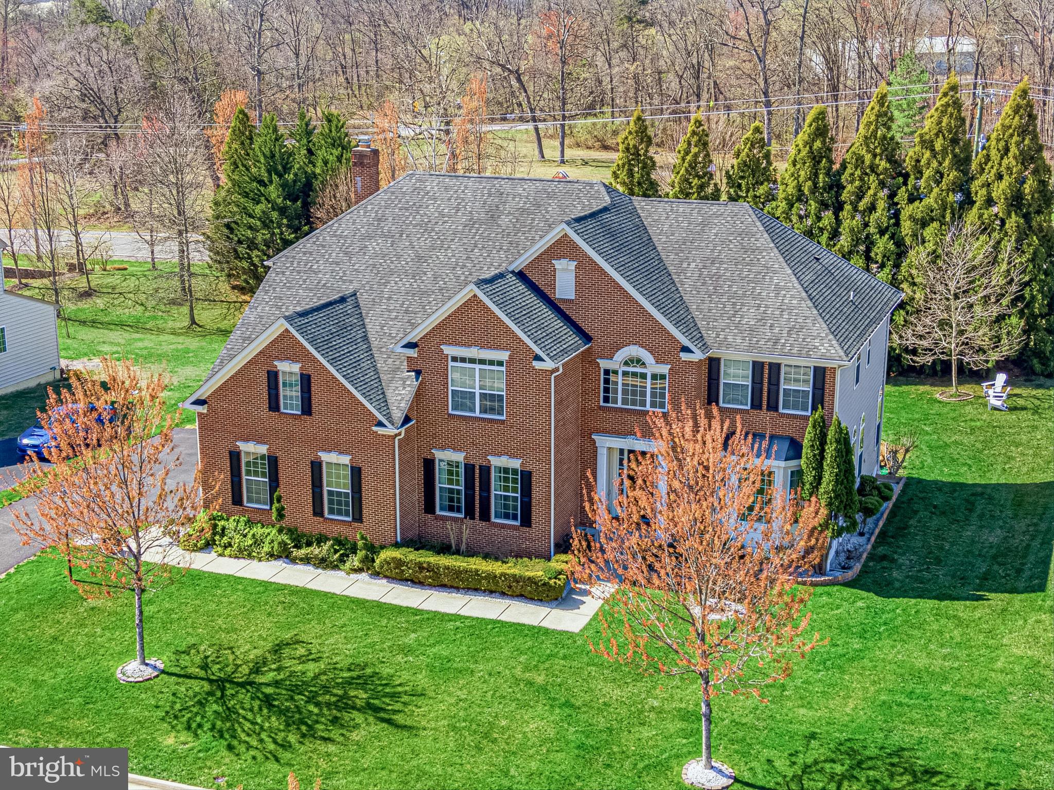 A timeless blend of elegance, warmth, and thoughtful design - this beautifully appointed home welcomes you with a sense of ease from the very first step inside.

A charming front walkway leads to the covered porch and into a grand two-story foyer, with front and back staircases connecting all three levels with ease. Sunlight fills the main level, highlighting hardwood floors, detailed moldings, and spaces designed for both everyday living and entertaining. A private study with French doors offers a quiet work-from-home retreat, while the formal living and dining rooms create an inviting setting for gatherings.

At the heart of the home, the gourmet kitchen features granite countertops, a center island with breakfast bar seating, and stainless steel appliances. The breakfast area opens to a slate patio with pergola, overlooking a tree-lined backyard - perfect for morning coffee or evenings outdoors. The kitchen flows seamlessly into the family room, anchored by a floor-to-ceiling stone, wood-burning fireplace and coffered ceiling. A mudroom drop zone, laundry and sorting room with utility sink, renovated powder room, and access to the three-car garage complete the main level.

Upstairs, the primary suite offers a true retreat with double-door entry, vaulted ceilings, a sitting area, walk-in closet, and a spa-like bath with dual vanities, soaking tub, and walk-in shower. Three additional bedrooms provide generous space, each with ample closets and en suite or Jack-and-Jill baths. A vaulted loft adds flexibility for a home office, reading area, or play space.

The fully finished lower level expands the home’s living space with a walk-out (stairs) recreation room, wet bar with seating, theatre room with projector and screen, a versatile bonus room for guests, gym, or hobbies, and a full bath. Engineered hardwood flooring, recessed lighting, and direct backyard access make this level ideal for both relaxing and entertaining.

Outside, the tree-lined yard and landscaping create a peaceful setting with space to gather or play. Ideally located, the home offers a sense of countryside living with convenient access to Dulles International Airport, Route 50, and Route 15. Nearby Brambleton Town Center and the Village at Leesburg offer shopping, dining, and entertainment, while Hal and Berni Hanson Regional Park provides trails, fields, and open green space. Wineries, breweries, farmers markets, and the charm of Middleburg and downtown Leesburg are all just minutes away.

Recent updates include hardwood flooring added to the family room and a renovated powder room (Spring 2025), new microwave and dishwasher (Fall 2025), pergola installation (Summer 2024), additional landscaping with river rocks and plantings (2023), and kitchen backsplash update (Summer 2022). The lower level was finished in Spring 2015, along with chandeliers and custom drapes. HVAC condensers, furnaces, and heat pump have all been replaced within the last six years.

A home that offers space to gather, room to grow, and a setting to truly enjoy - this is where everyday living feels elevated, and where you won���t want to miss your chance to call it home!
